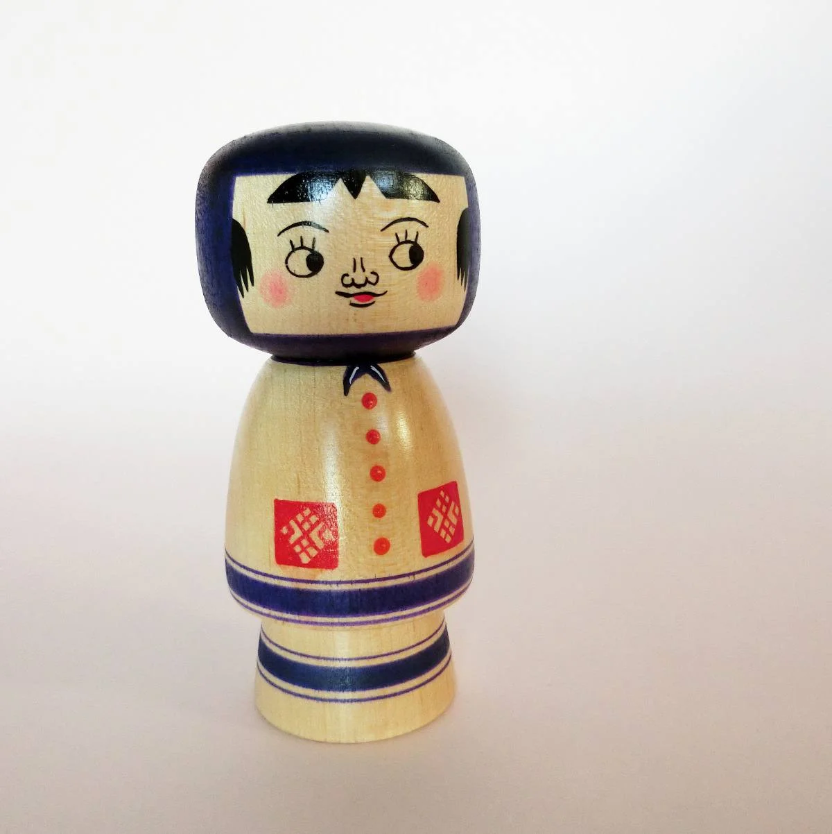 Purple kokeshi doll in creative style