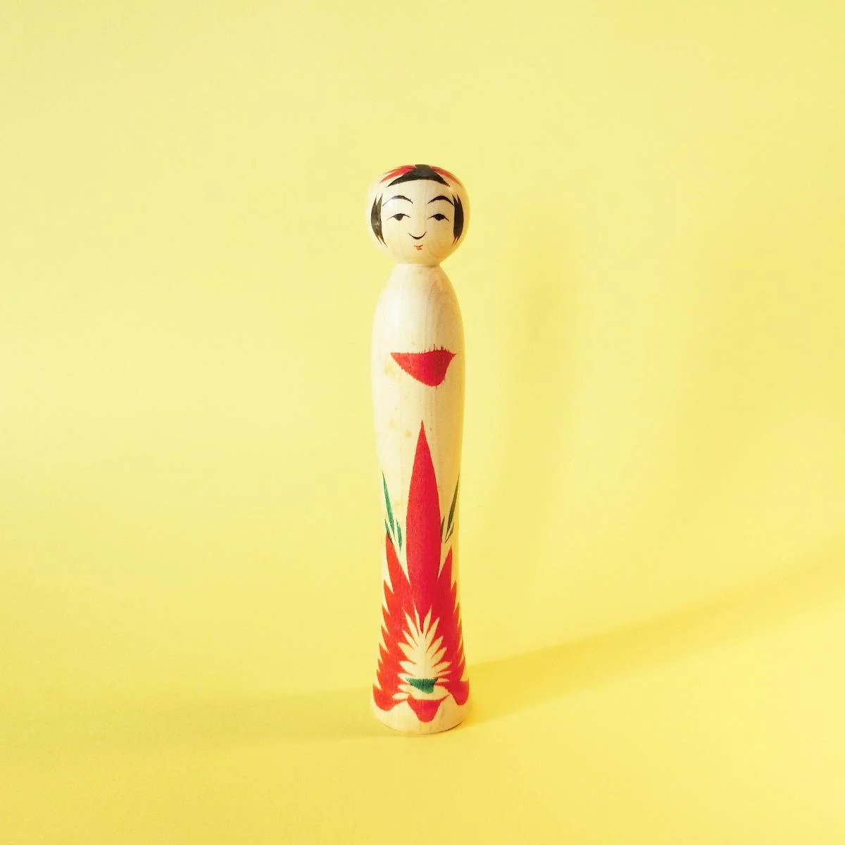 Tiny kokeshi doll in traditional, Naruko style