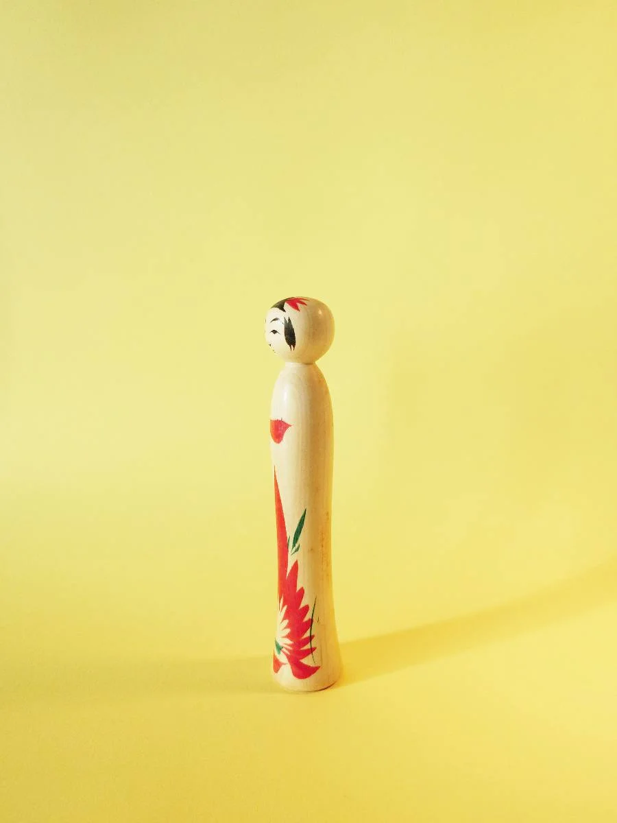 Tiny kokeshi doll in traditional, Naruko style