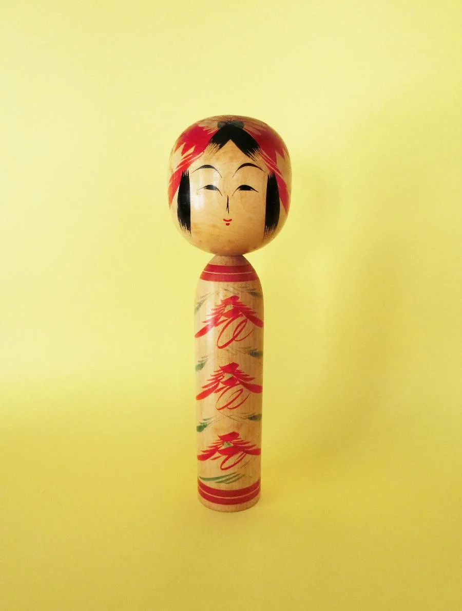 Vintage kokeshi doll in Togatta style