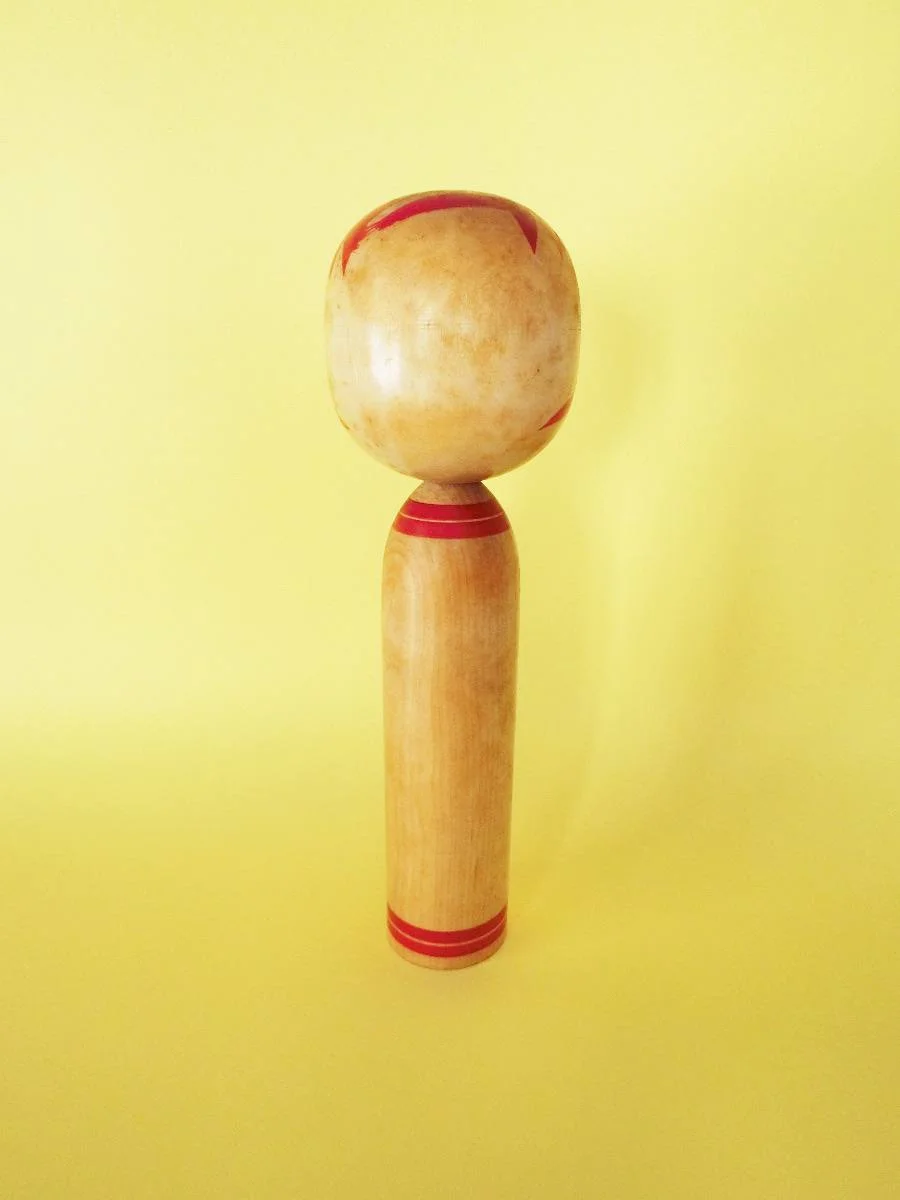 Vintage kokeshi doll in Togatta style