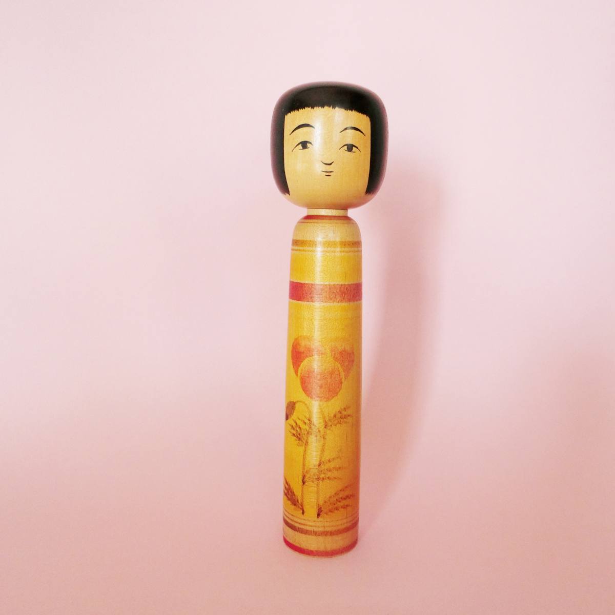 Yellow Tsugaru kokeshi by Hasegawa Kenzo
