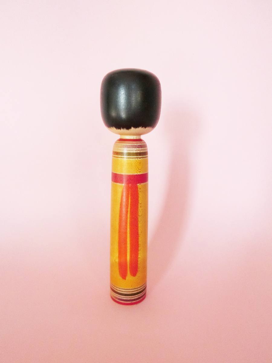 Yellow Tsugaru kokeshi by Hasegawa Kenzo