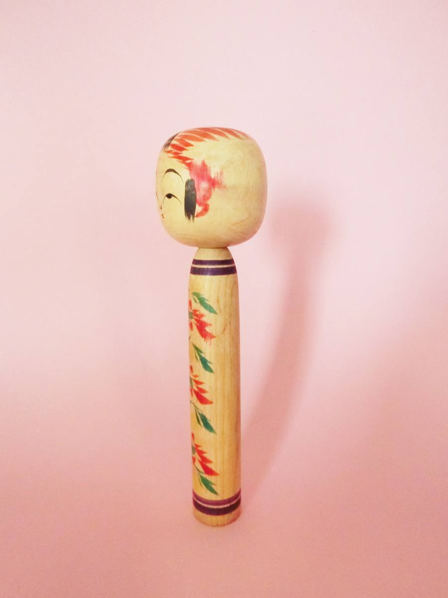 Traditional kokeshi doll in Togatta style