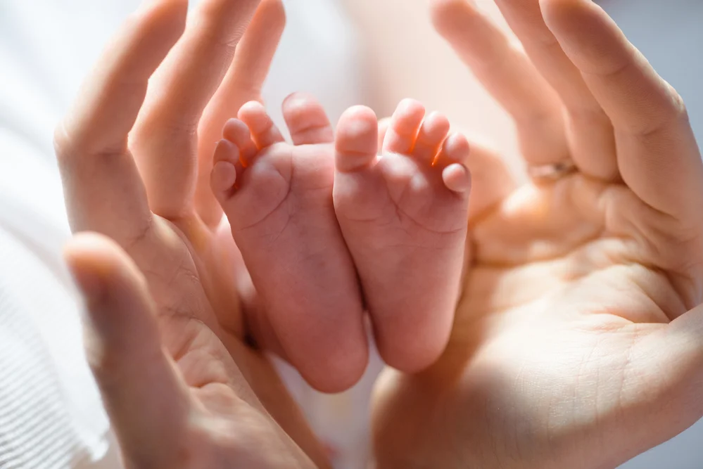 Baby feet Adult hands.jpg