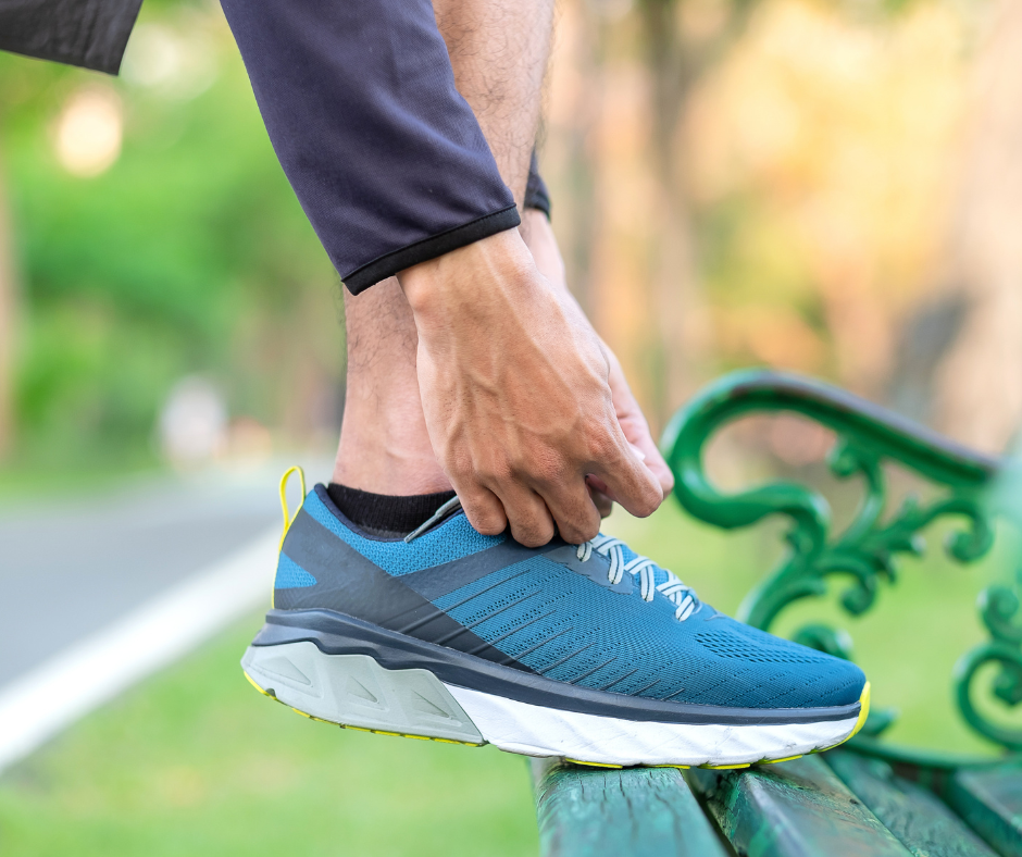 man tying running shoe