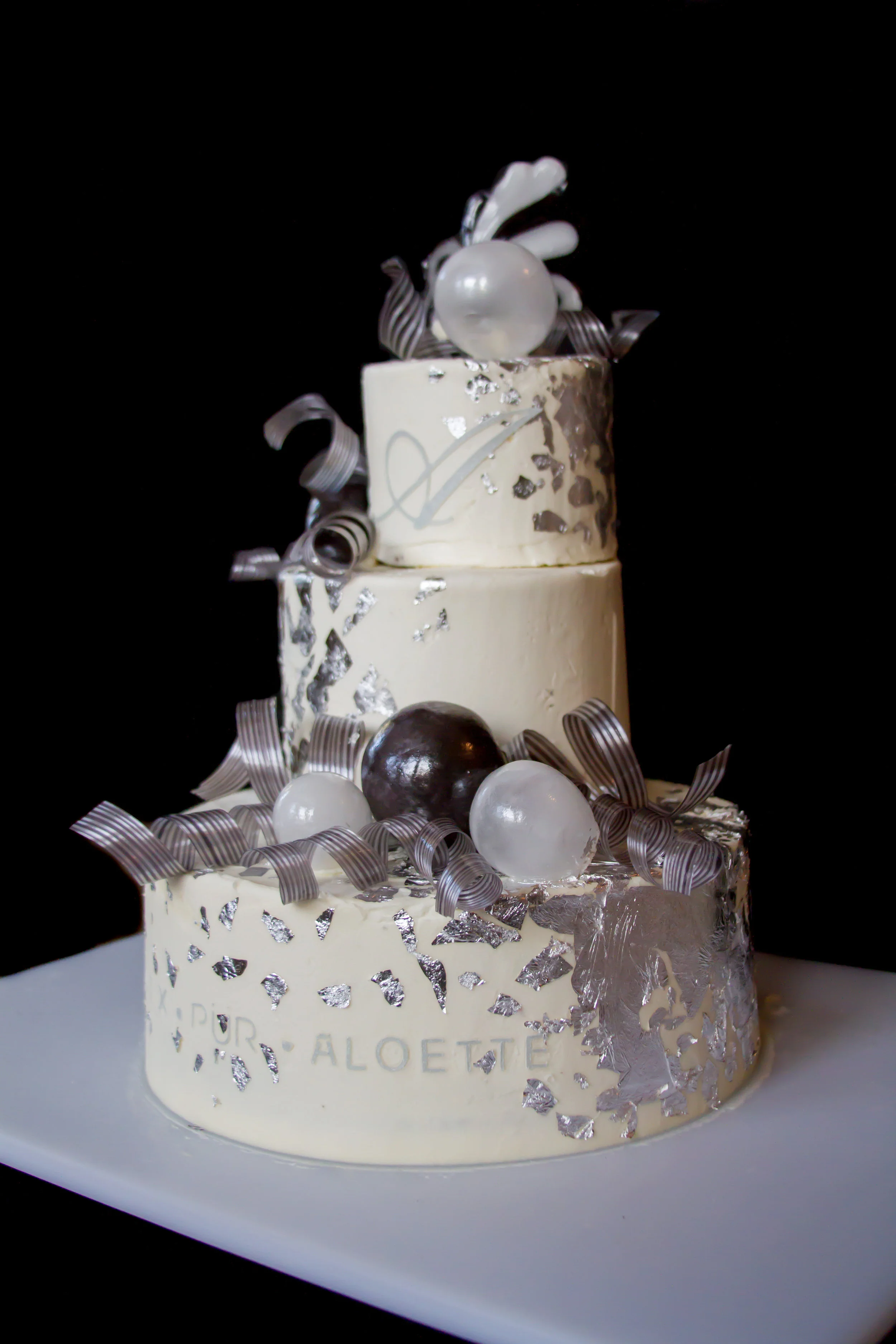 Silver Leaf, Blown Sugar orbs, and Pulled Sugar Ribbons on a cake. Photo Courtesy of Annah Hamby Photography
