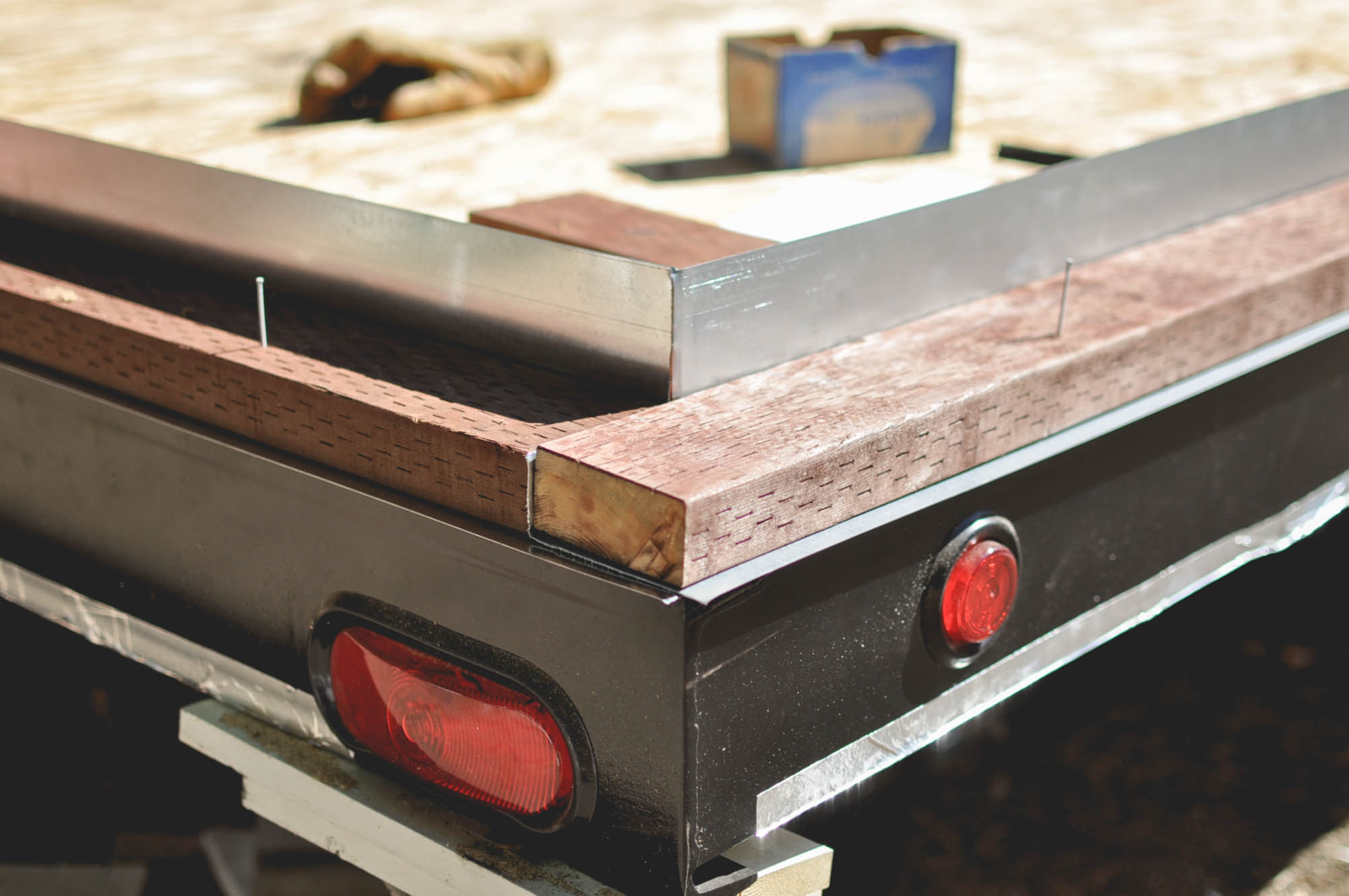 This is a shot of a corner with the L-flashing and sills in place, waiting to be bolted down to the trailer frame. The white nails mark the locations of the anchor bolts.