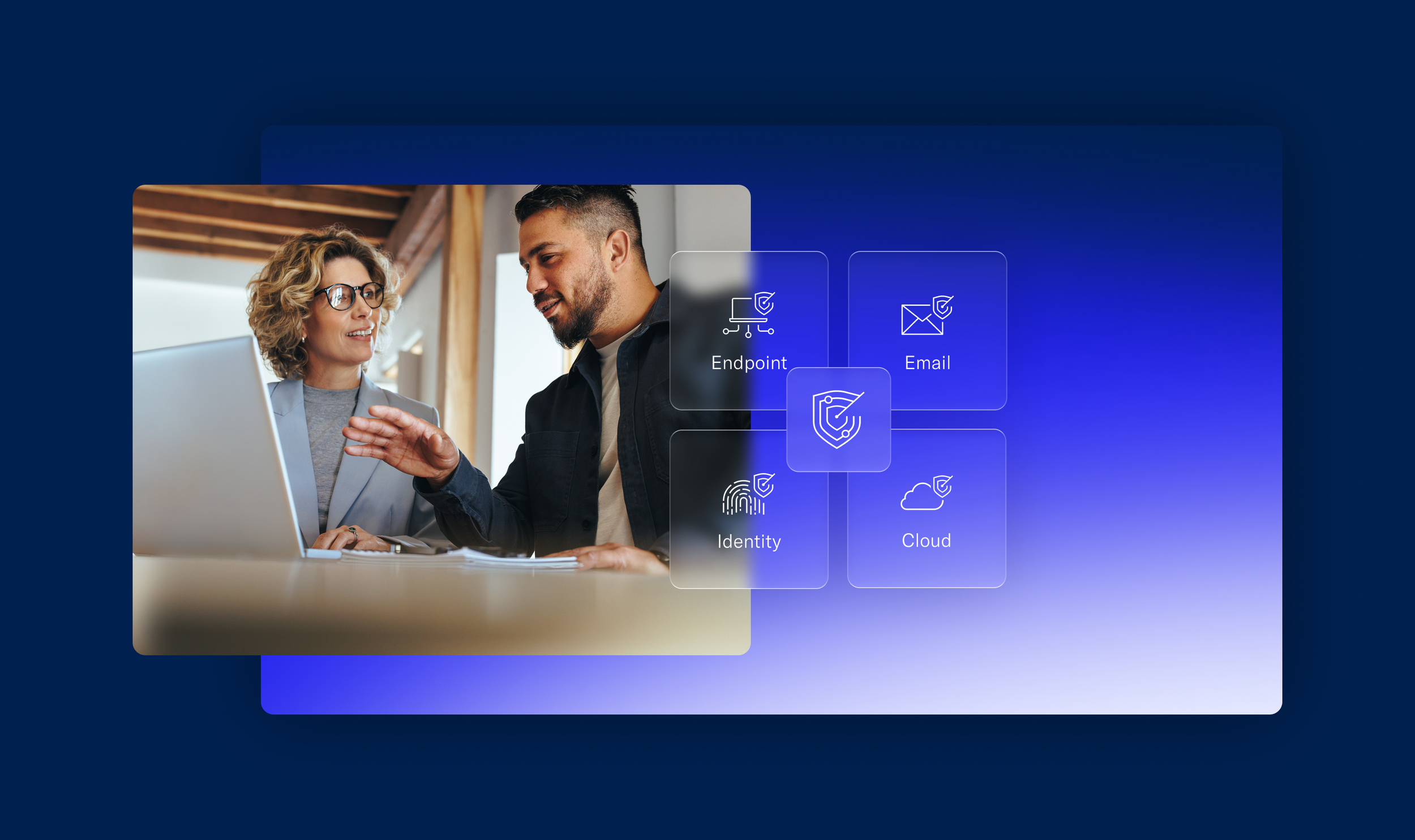 Two people discussing in front of a laptop, with digital graphics overlay showing cybersecurity-related icons for Endpoint, Email, Identity, and Cloud.