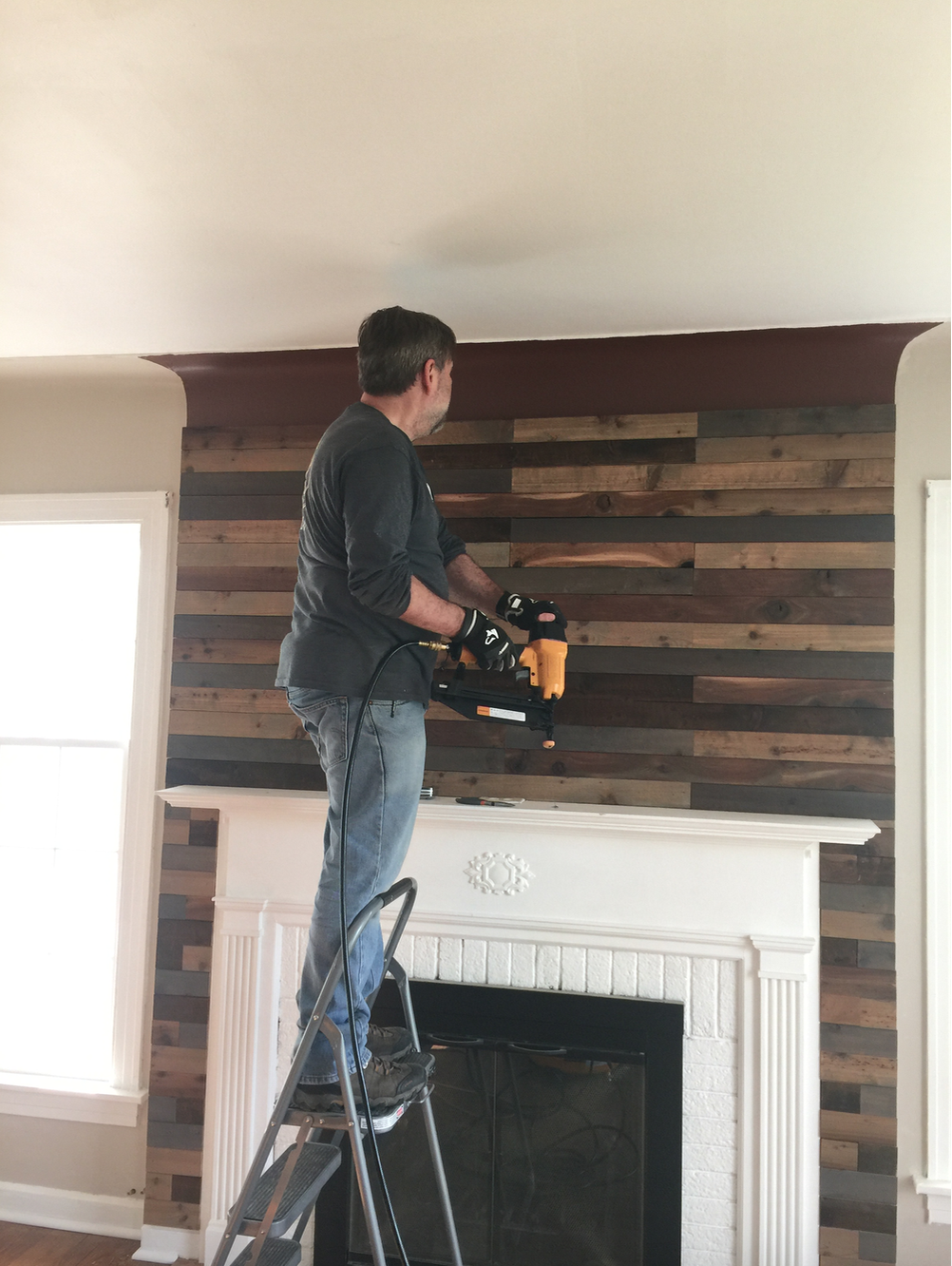 As hubby worked his way up to the ceiling, the wall curves a bit. Cutting the boards in half lengthwise helped the boards fit better. 