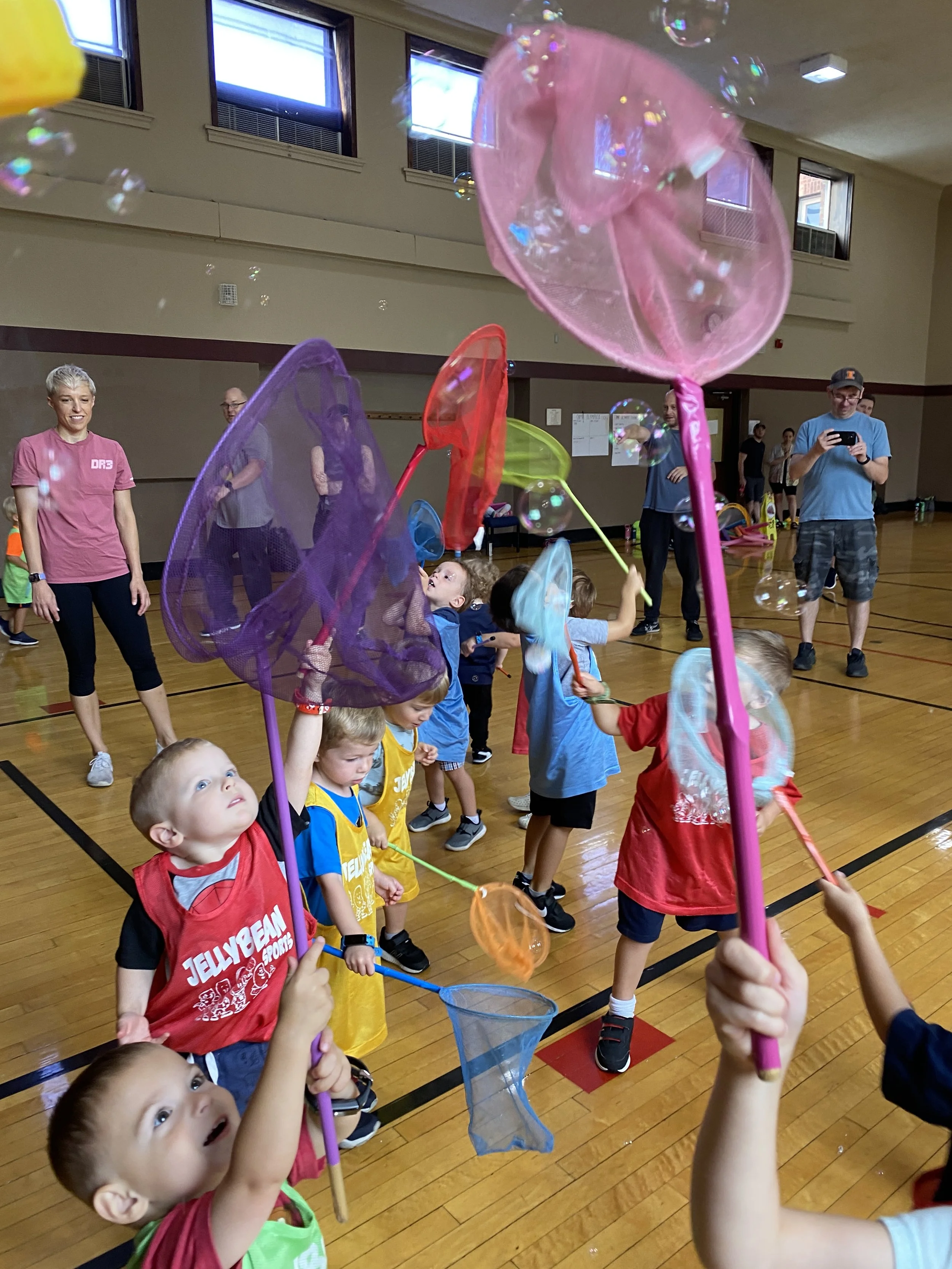 When people about the sport of lacrosse, they don't often see it in their minds with little kids playing it. But this picture represents exactly what the Jelly Way does, it keeps lacrosse simple and makes learning fun using bubbles and butterfly nets