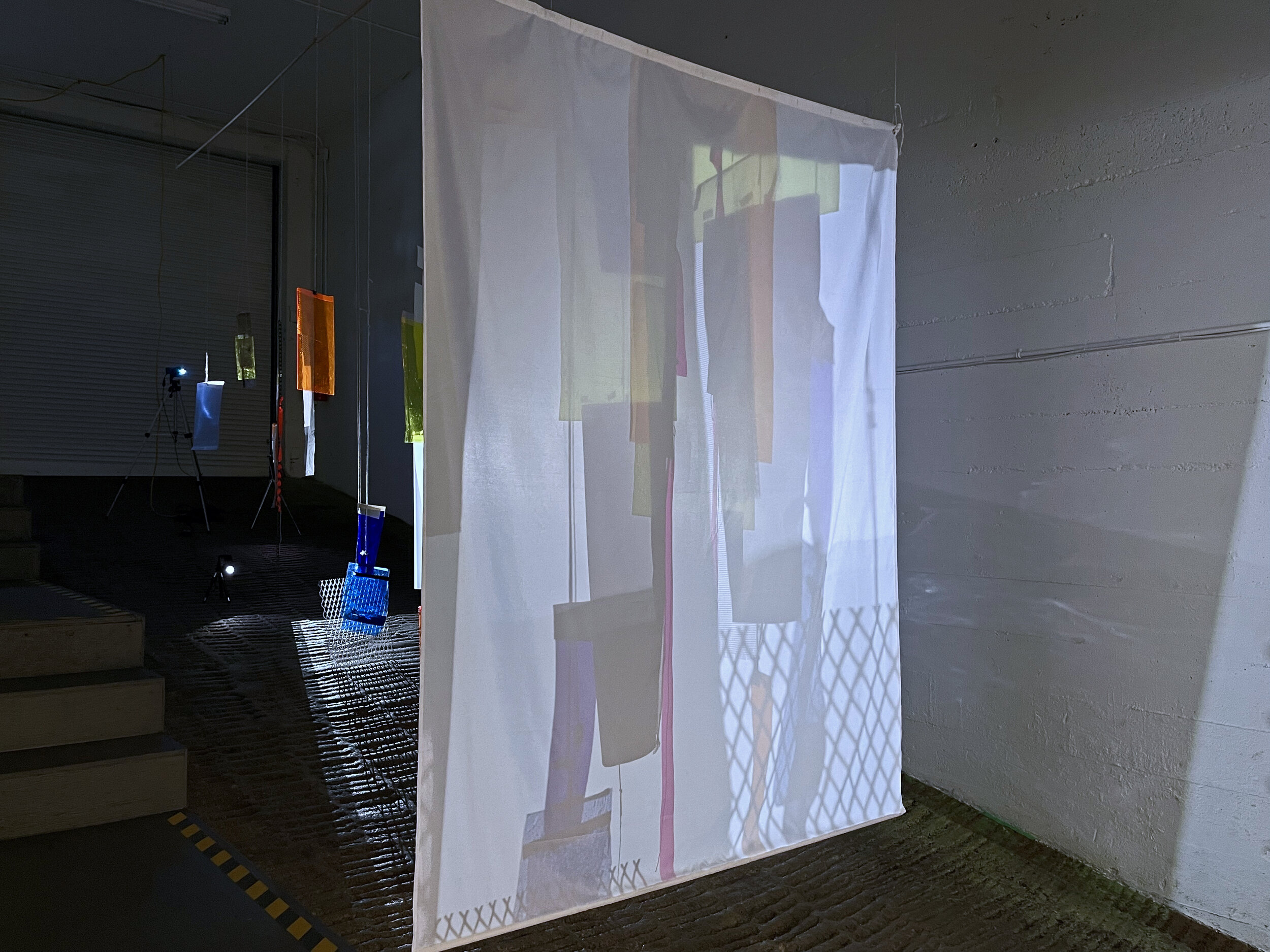   Arising,    acetate, cardboard, corrugated steel, rope, mesh, found objects, various tapes, shower curtain, dowels, chain and digital projectors on tripods (x3)  2021 