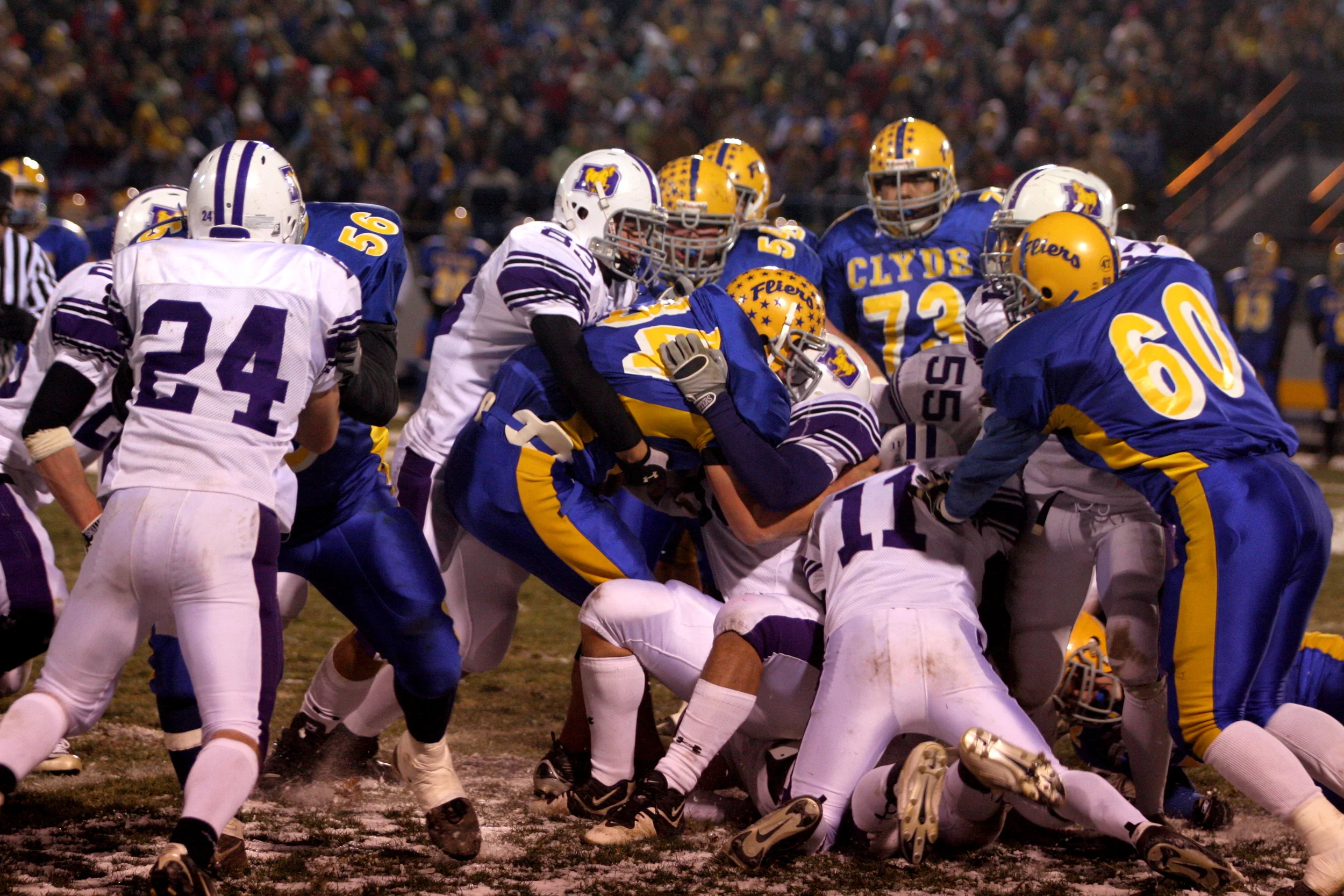 David Knapke (83) and a Stallion teammate wrap-up a Clyde ball carrier in the DIII State Semifinal (photo credit - Barb Dougherty)