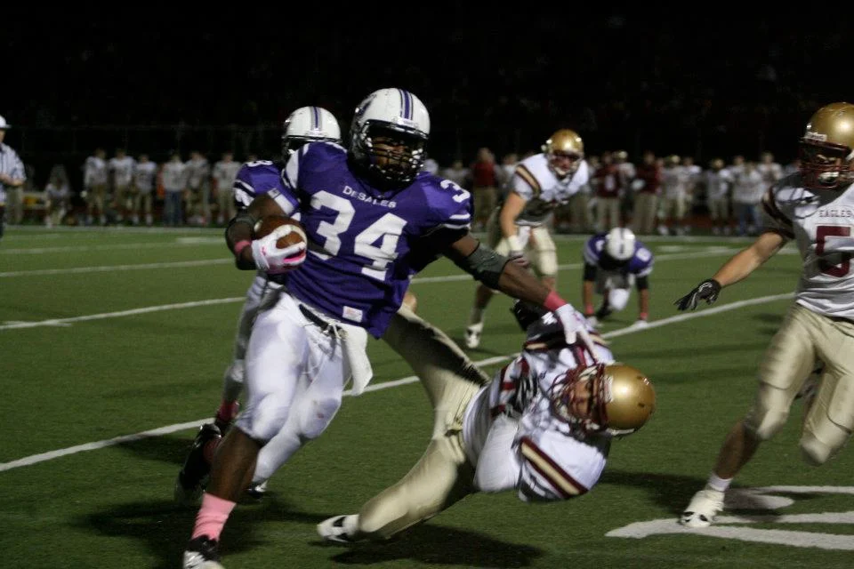 Warren Ball (34) delivers a punishing stiff arm, as part of his 195 rushing yards (photo credit - Barb Dougherty)