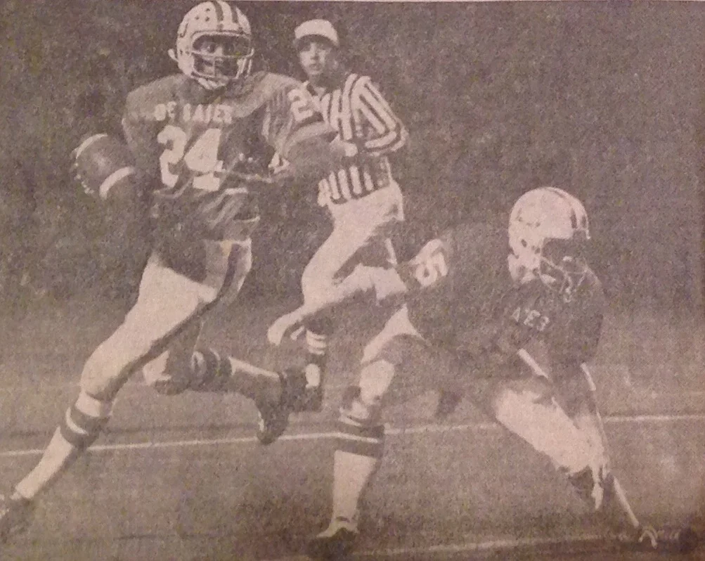 Junior quarterback Eric Holleman (24) rolls out with fullback John Lawson (45) providing the protection