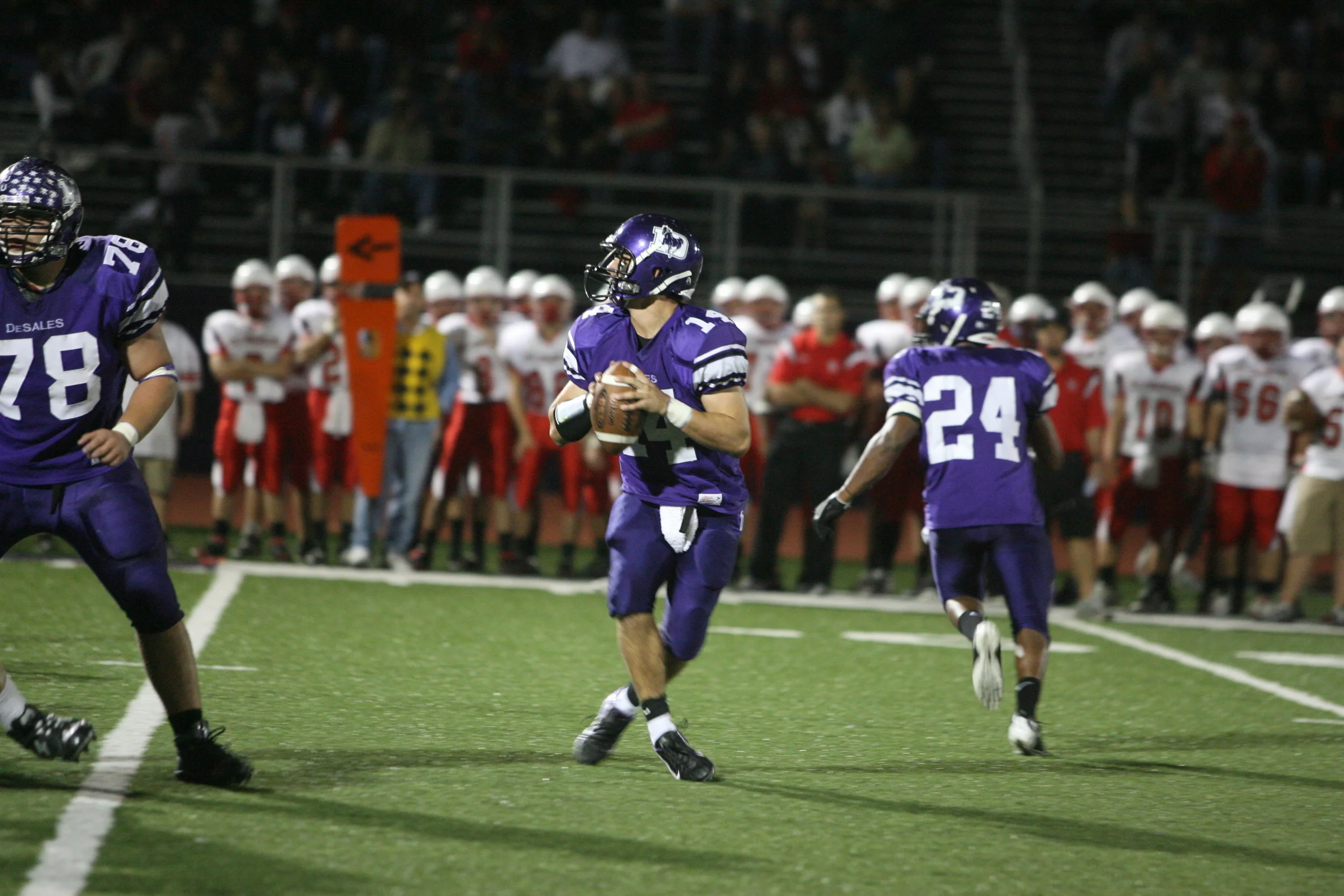 With Jake Smith (78) blocking, Thomas Gentile (14), who finished 181 yards of offense, surveys the field. (photo credit - Barb Dougherty)