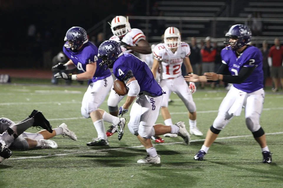 Jake Gilmore (4) takes the handoff from Josh DeLozier (2) and picks up some of his game-high 141 yards (photo credit - Barb Dougherty)