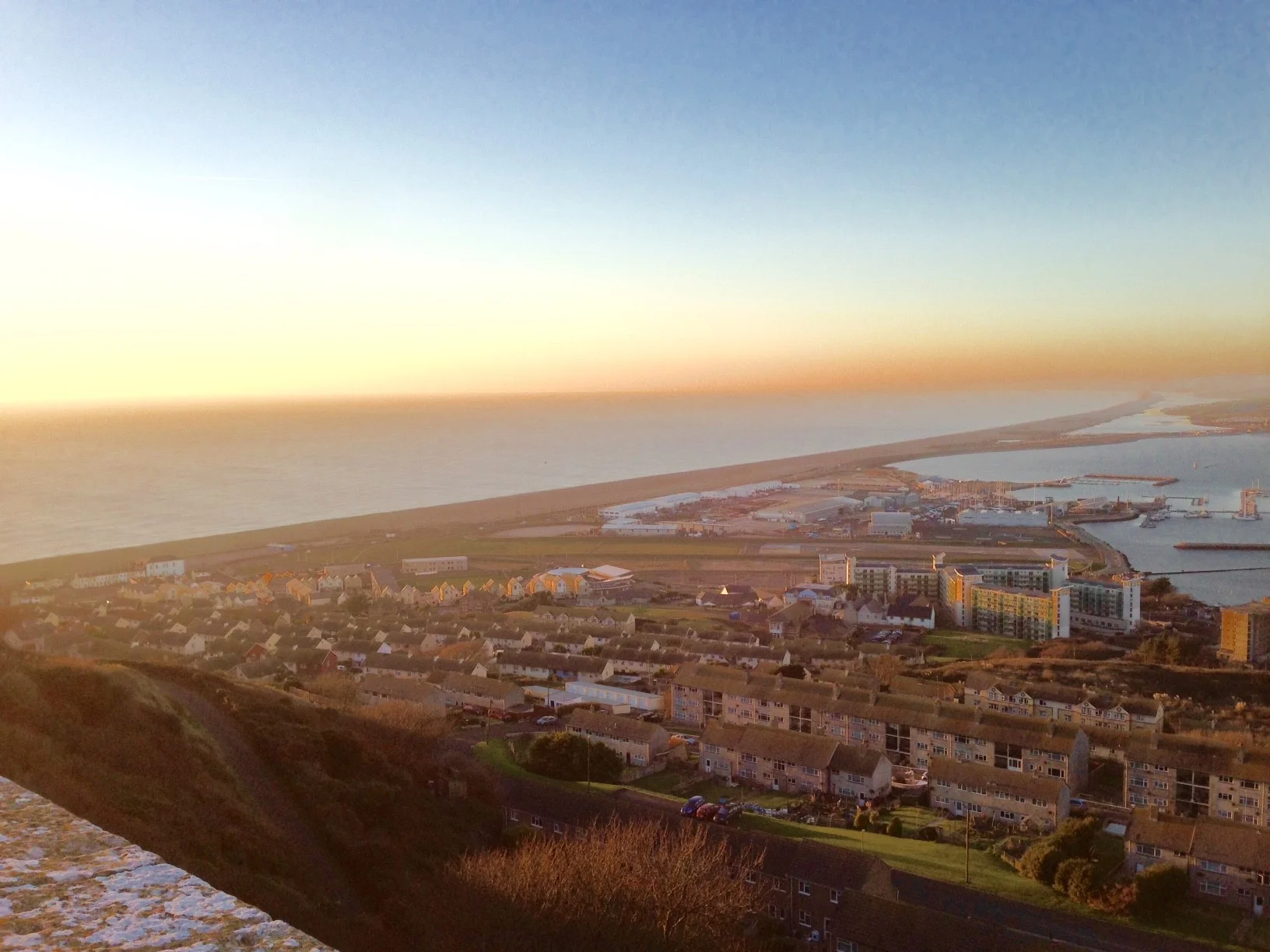 The view from the top of Portland Hill overlooking Chesil Beach and Weymouth in the distance.