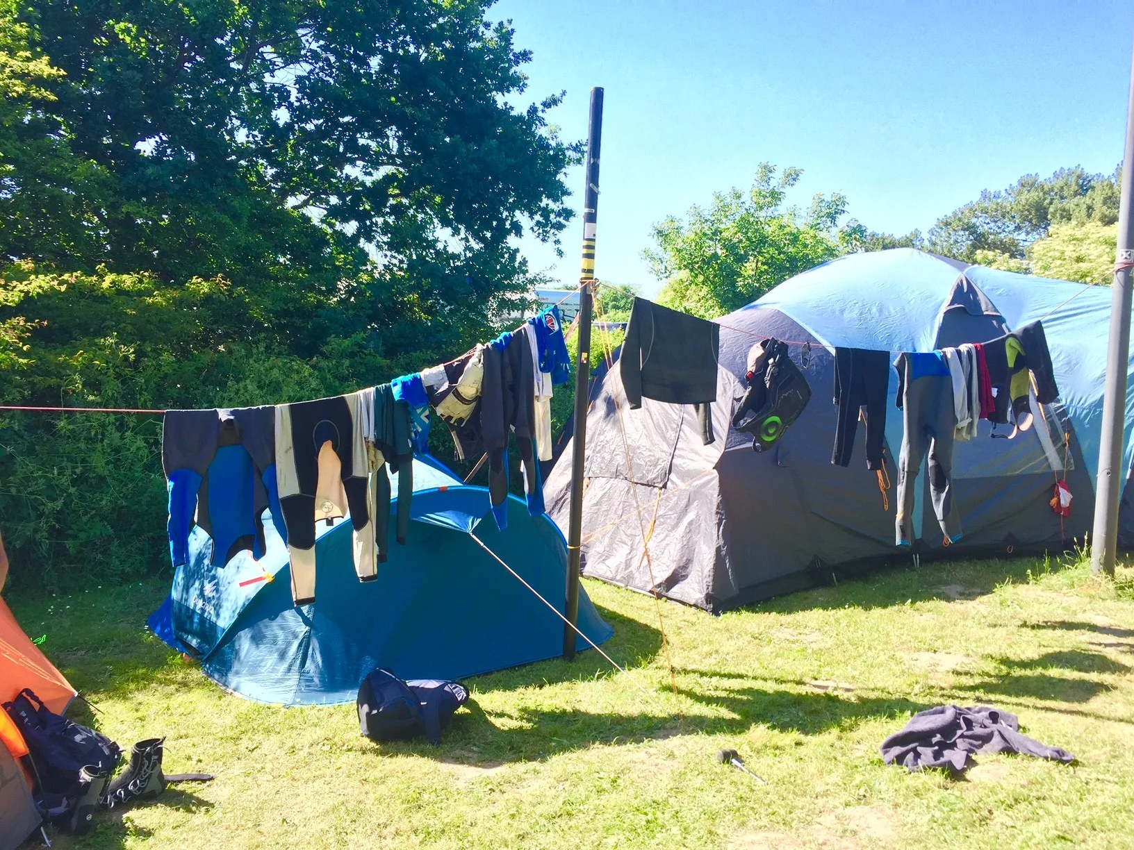 We had to think outside of the box for some things whilst camping. Here we set up a washing line to dry our sailing kit using an old mast and a mainsheet strung between a lamp post and car trailer. It worked surprisingly well!