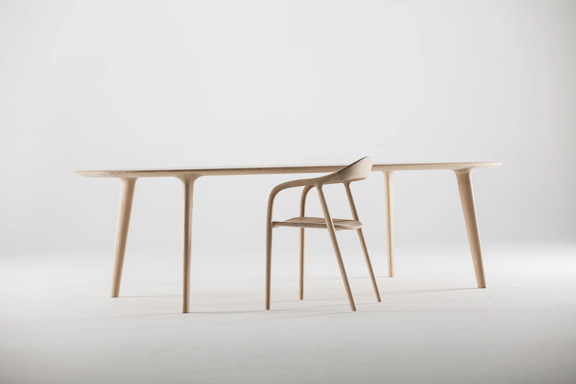 Luc table and Neva chair designed by Regular Company