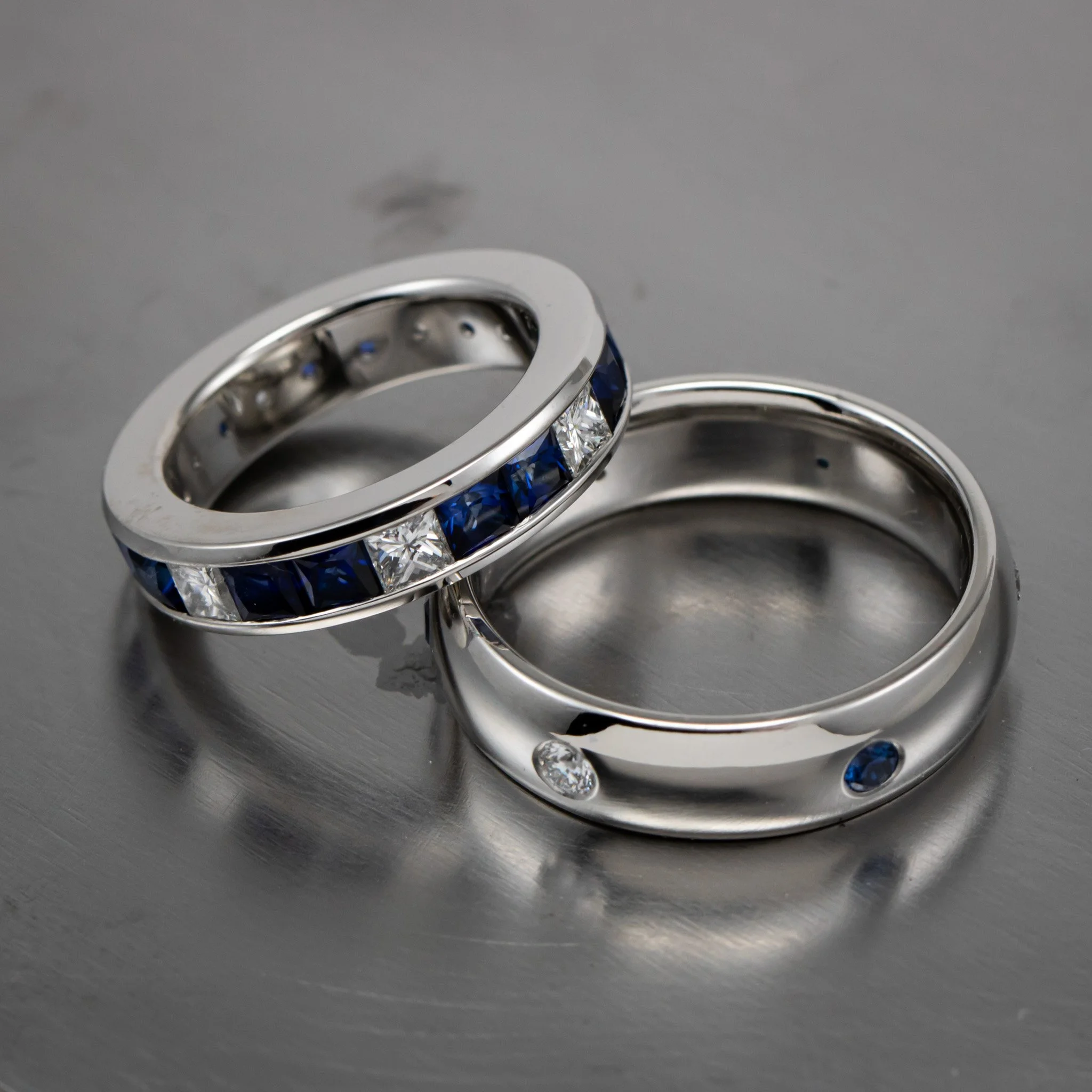 platinum-wedding-band-channel-set-diamonds-sapphires-princess-cut-eternity-band-laying-down.jpg