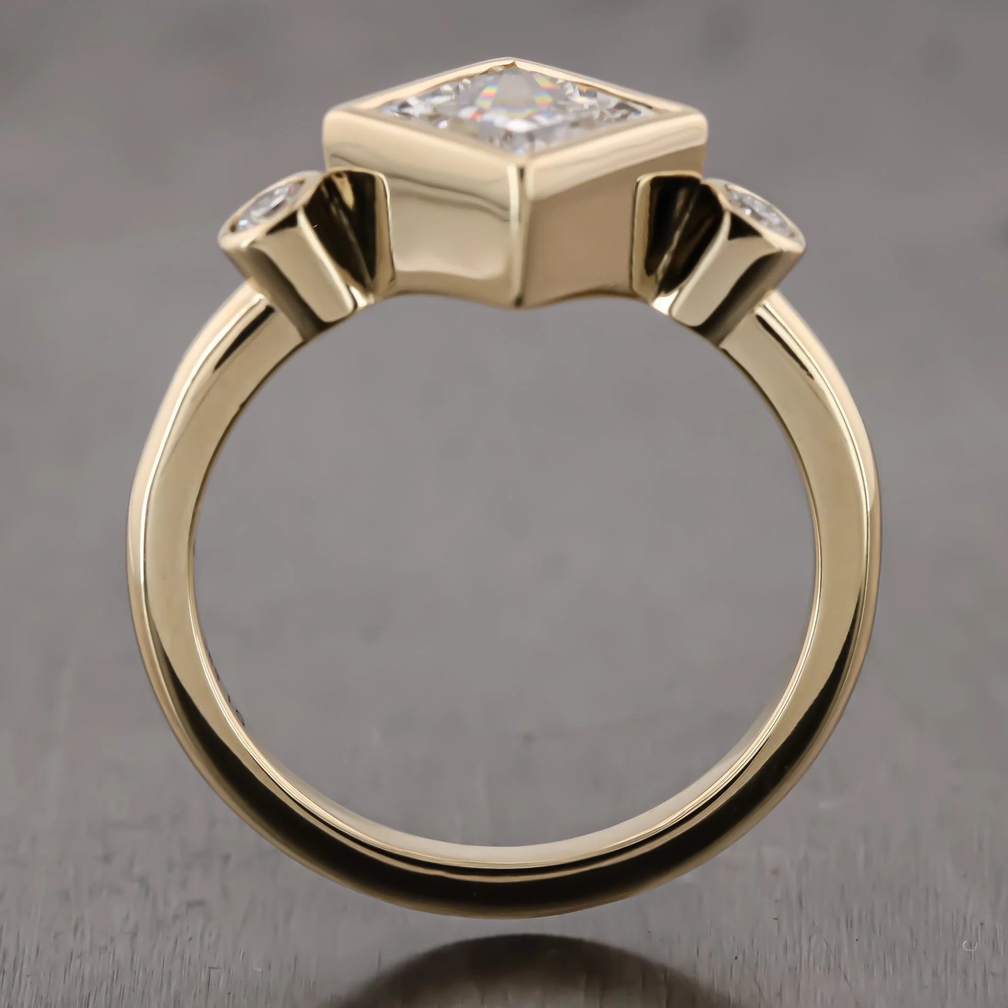 Gold ring with a square-shaped clear gemstone top