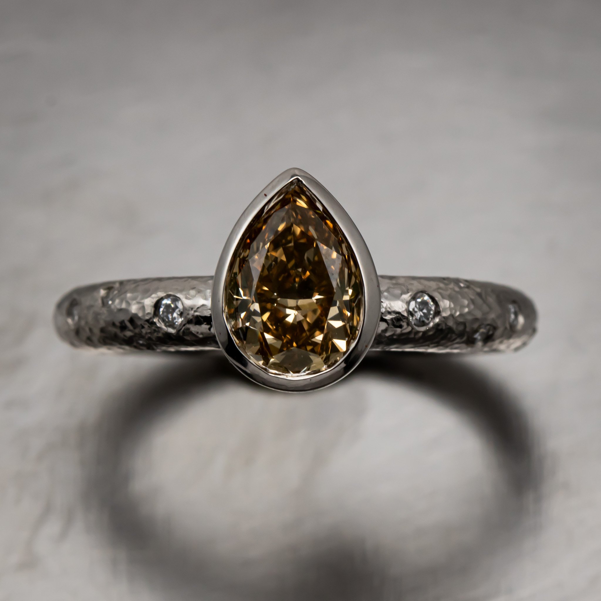 platinum-pear-cognac-diamond-bezel-hammered-flush-set-ring-top-view.jpg