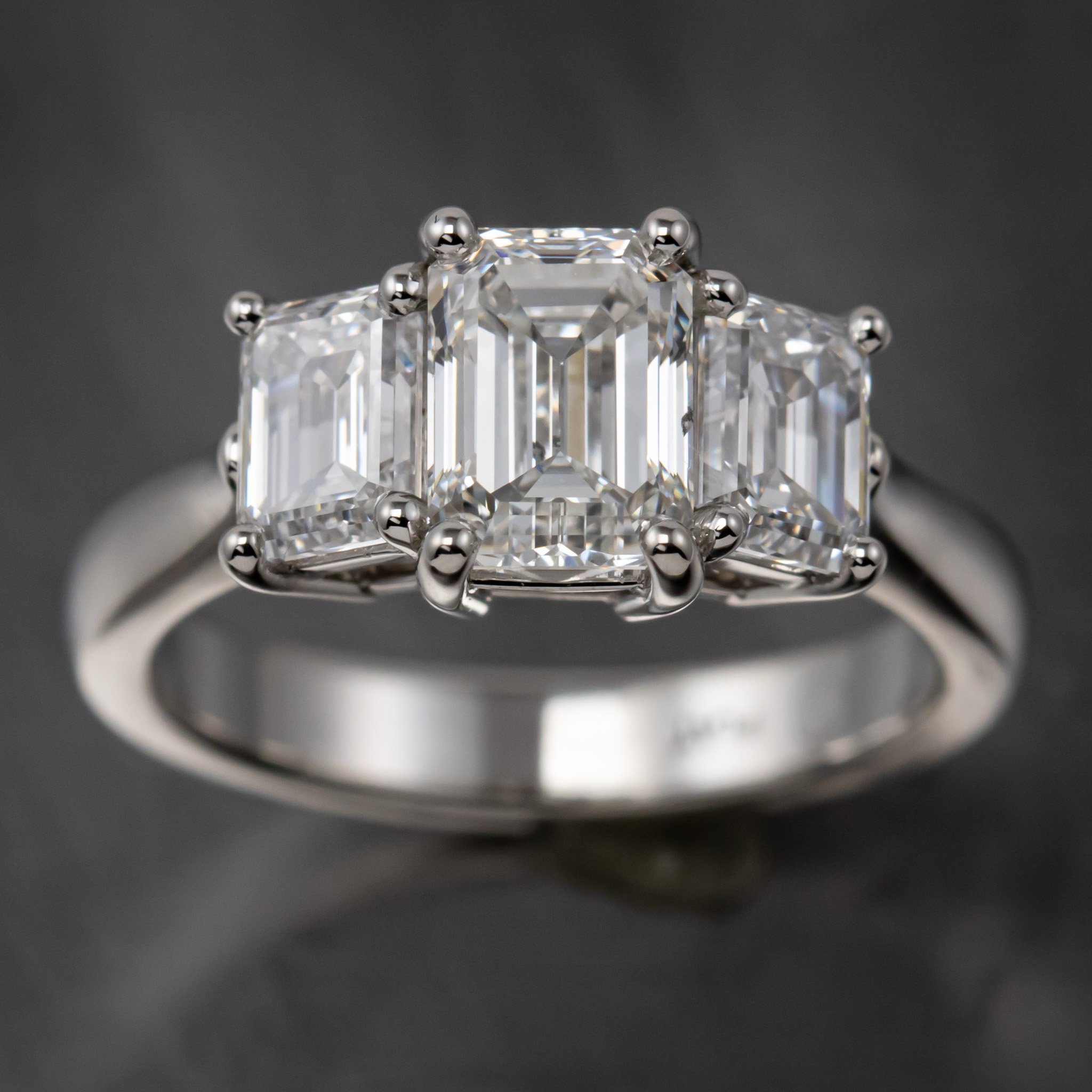 platinum-three-stone-emerald-cut-ring-prongs-top-view.jpg