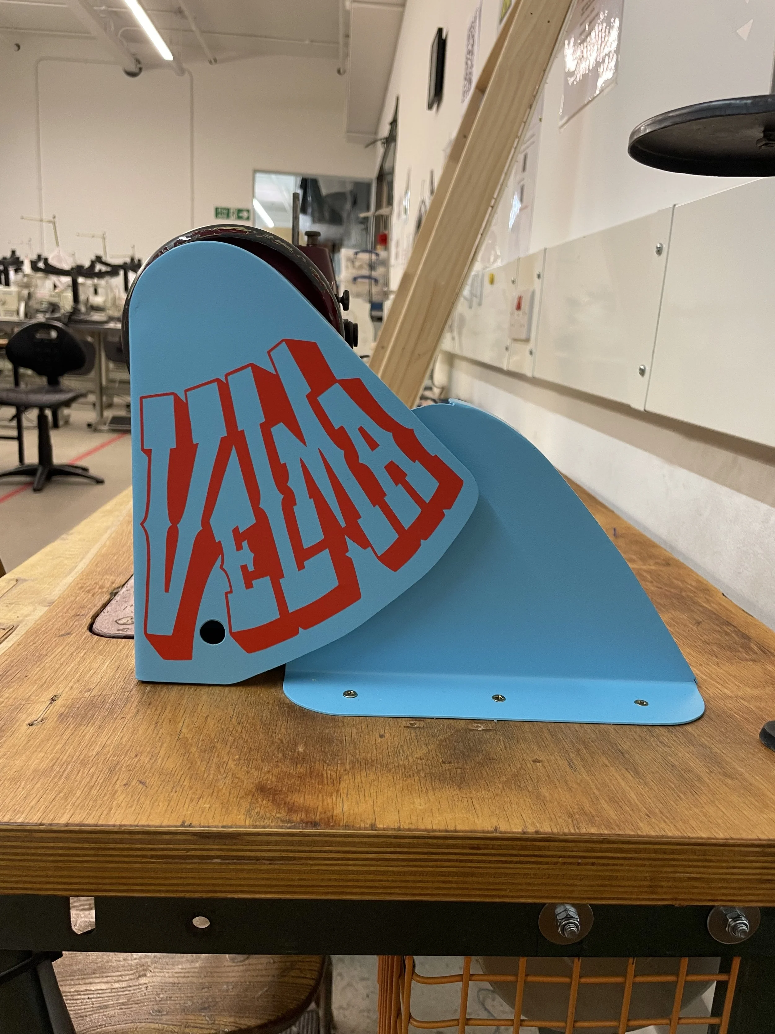  The type was hand drafted to specific triangular dimensions for appliqué on a custom safety guard. 