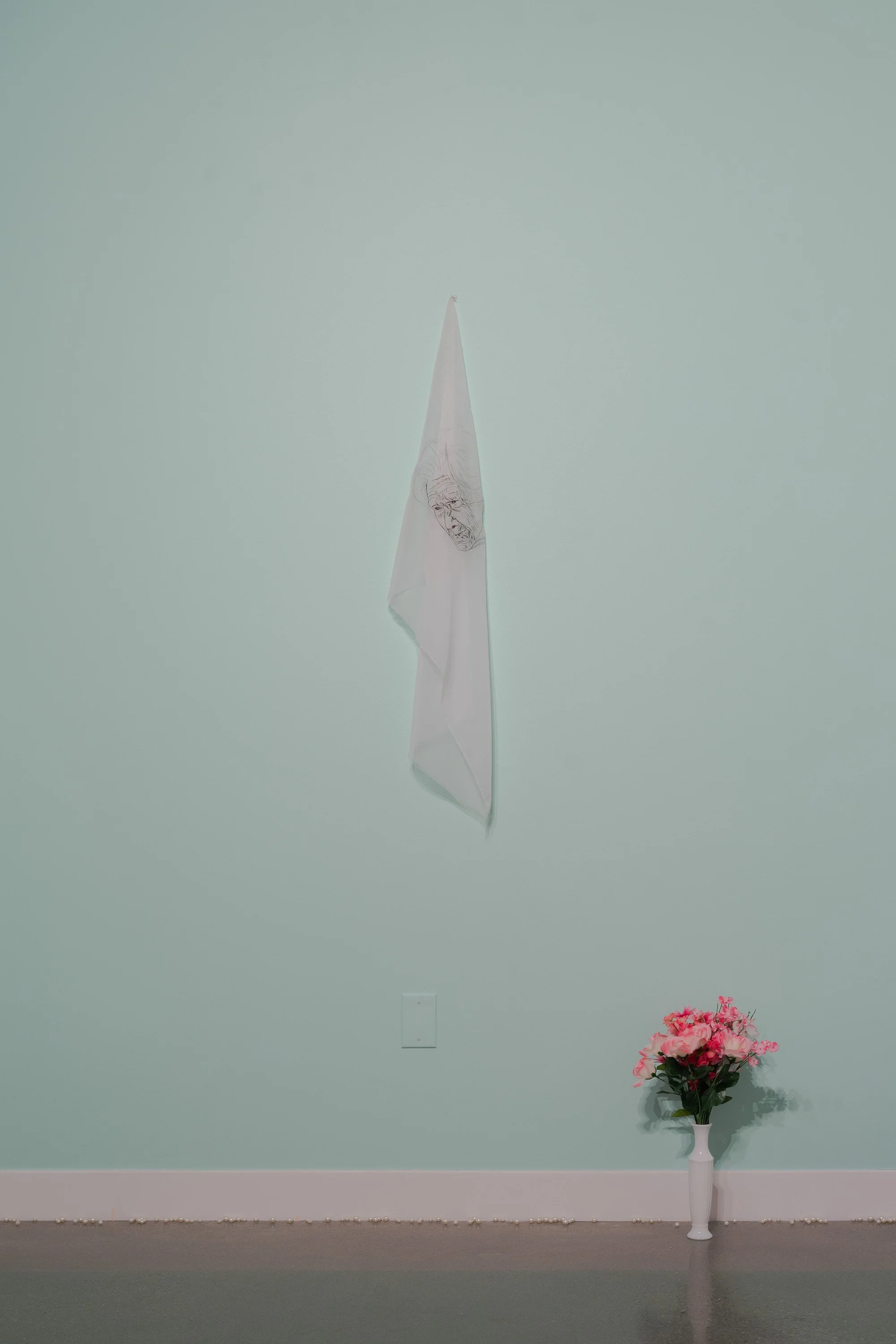   yo seré tu memoria (I will be your memory)   2022  the artist’s hair embroidered on fabric plus installation elements (paint, faux pearls, faux flowers, glass milk vase)  24 x 36 inches 