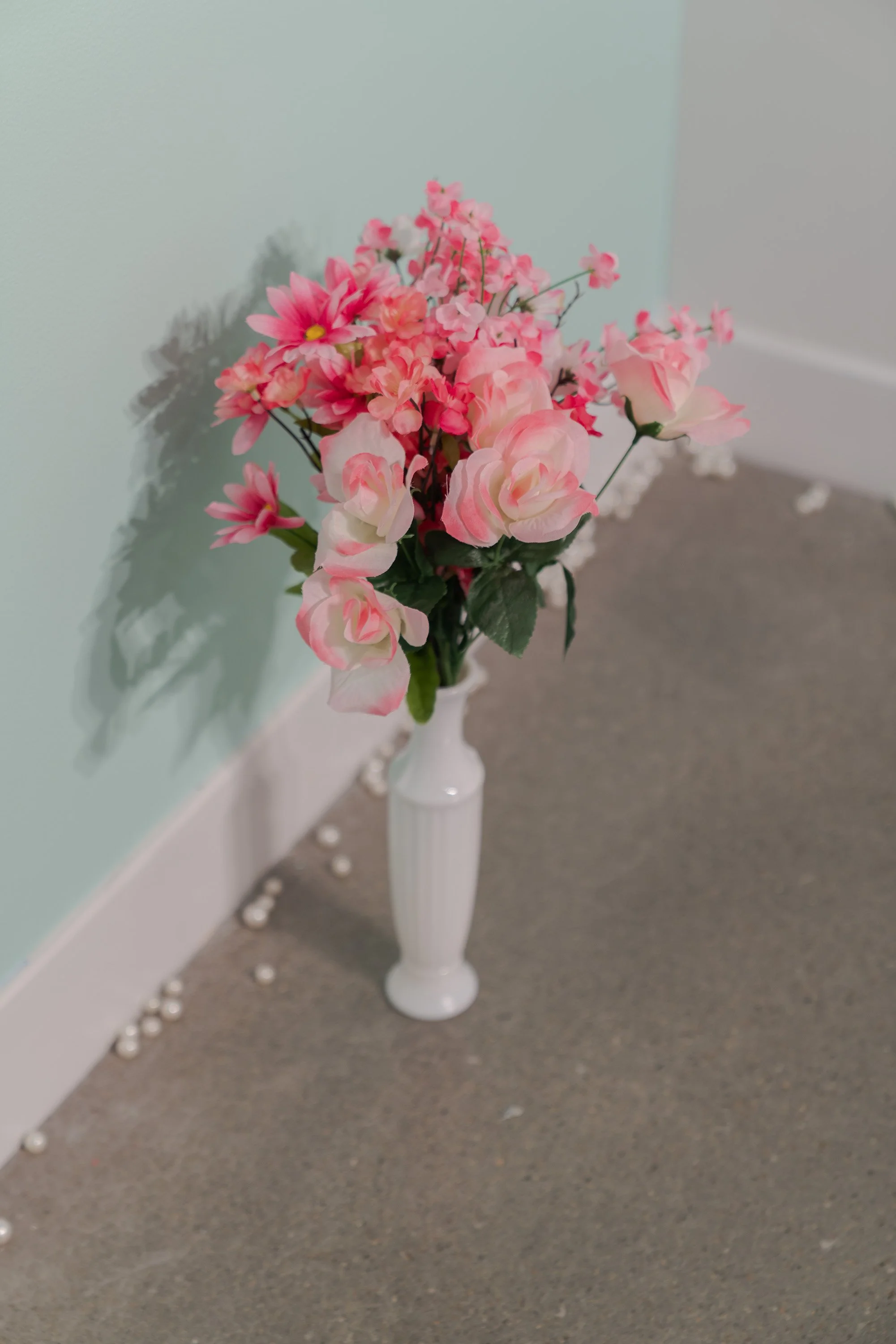   yo seré tu memoria (I will be your memory)   2022  the artist’s hair embroidered on fabric plus installation elements (paint, faux pearls, faux flowers, glass milk vase)  24 x 36 inches 