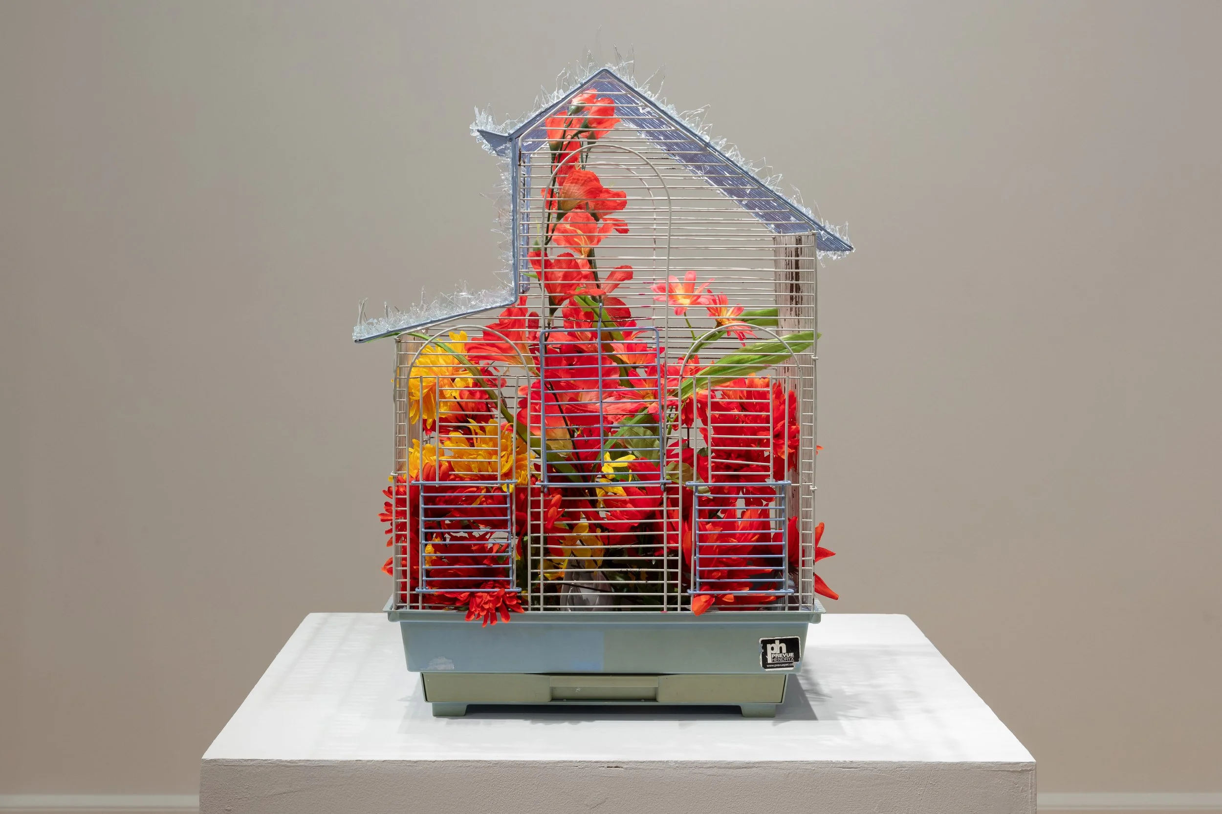   homenaje a los guardianes (homage to the guardians)   2024  birdcage, glass shards, faux flowers  18 x 16 x 25 inches 