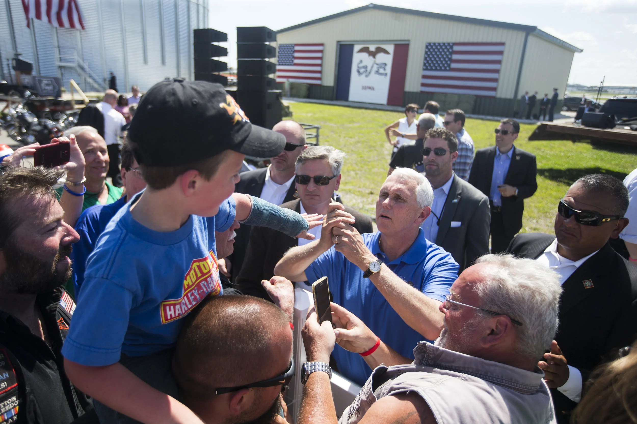  Tony Morgan lifts his son, Stetson Morgan, 7, of Guthrie Center, Iowa, on his shoulders to have his son's cast signed by Vice President Mike Pence after a speech during Joni Ernst's third annual Roast and Ride event, Saturday, June 3, 2017,  in Boon