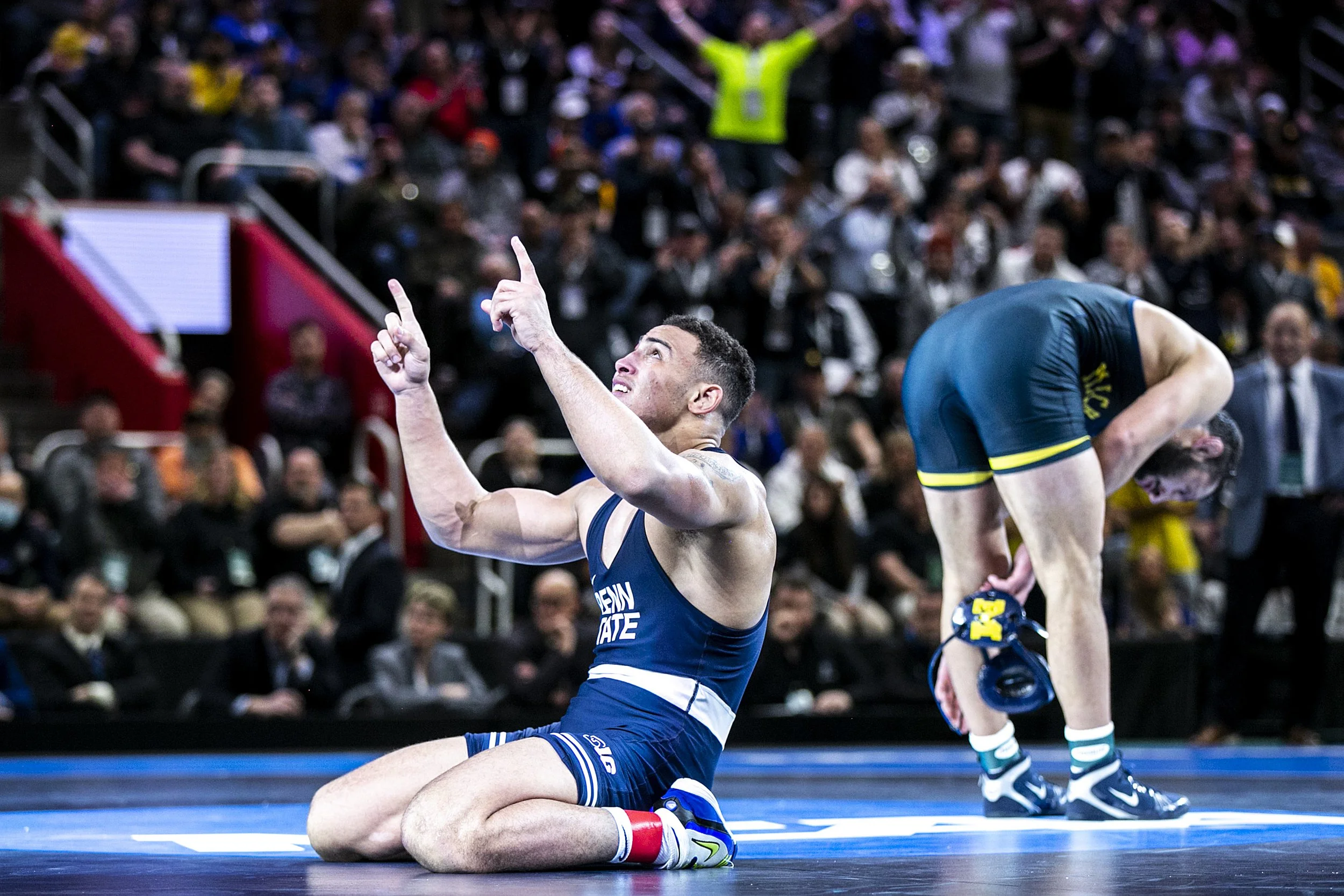  Penn State's Aaron Brooks, left, celebrates after scoring a decision against Michigan's Myles Amine at 184 pounds in the finals during the sixth session of the NCAA Division I Wrestling Championships, Saturday, March 19, 2022, at Little Caesars Aren