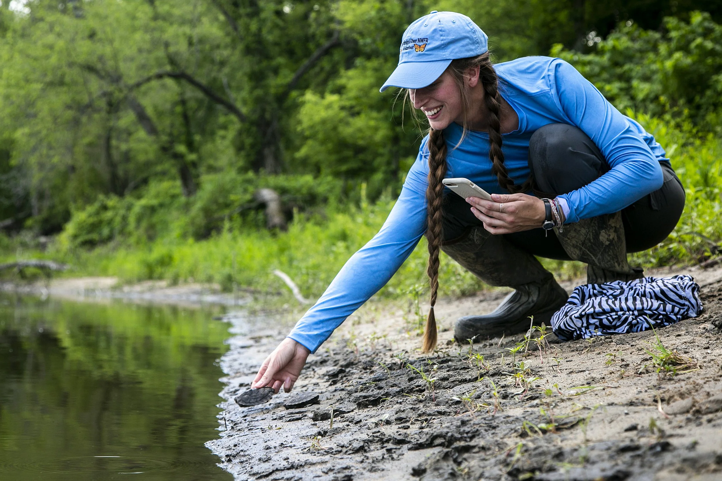  University of Northern Iowa student Rachel McDonnell, 25, helps release a group of false map turtles, Thursday, June 10, 2021, in a forest near Cedar Falls, Iowa. 