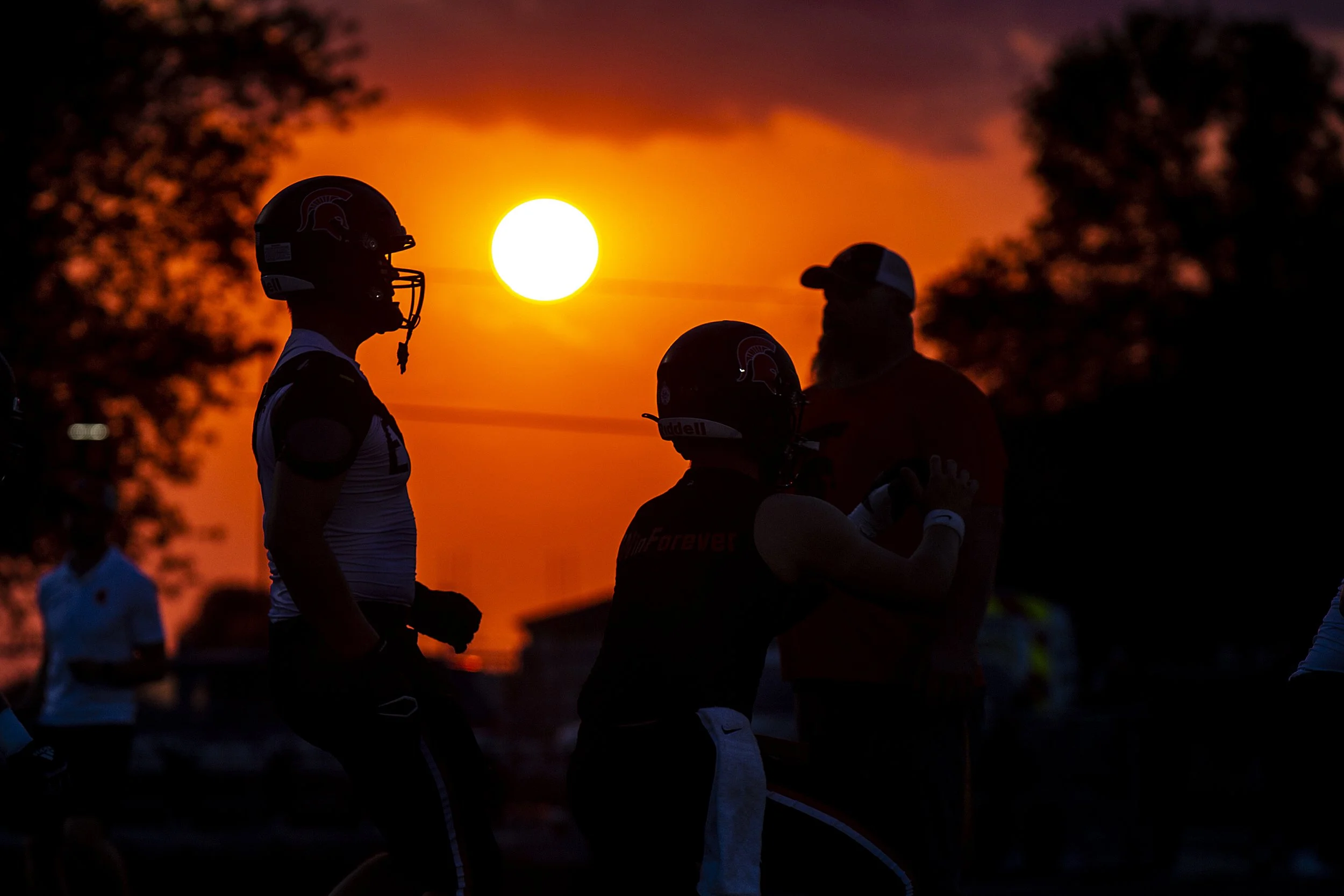  Solon Spartans players warm up as the sun sets before a high school football game against Mount Vernon, Friday, Sept. 2, 2022, at Spartan Stadium in Solon, Iowa. 