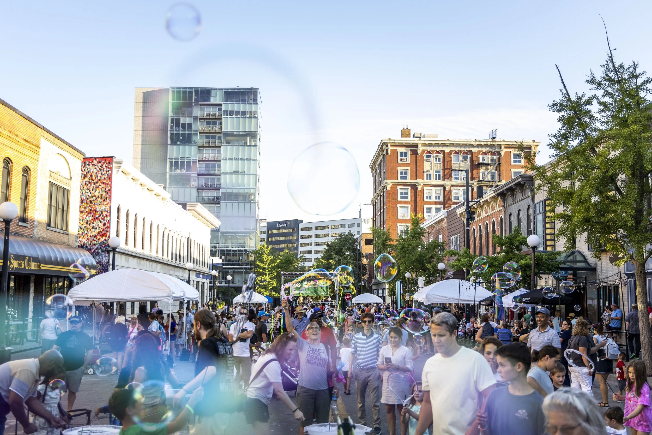  Bubbles fill the air as people listen to TheZeffsterr perform during Rock the Chalk presented by MidWestOne Bank, Friday, Aug. 11, 2023, in Iowa City, Iowa. 