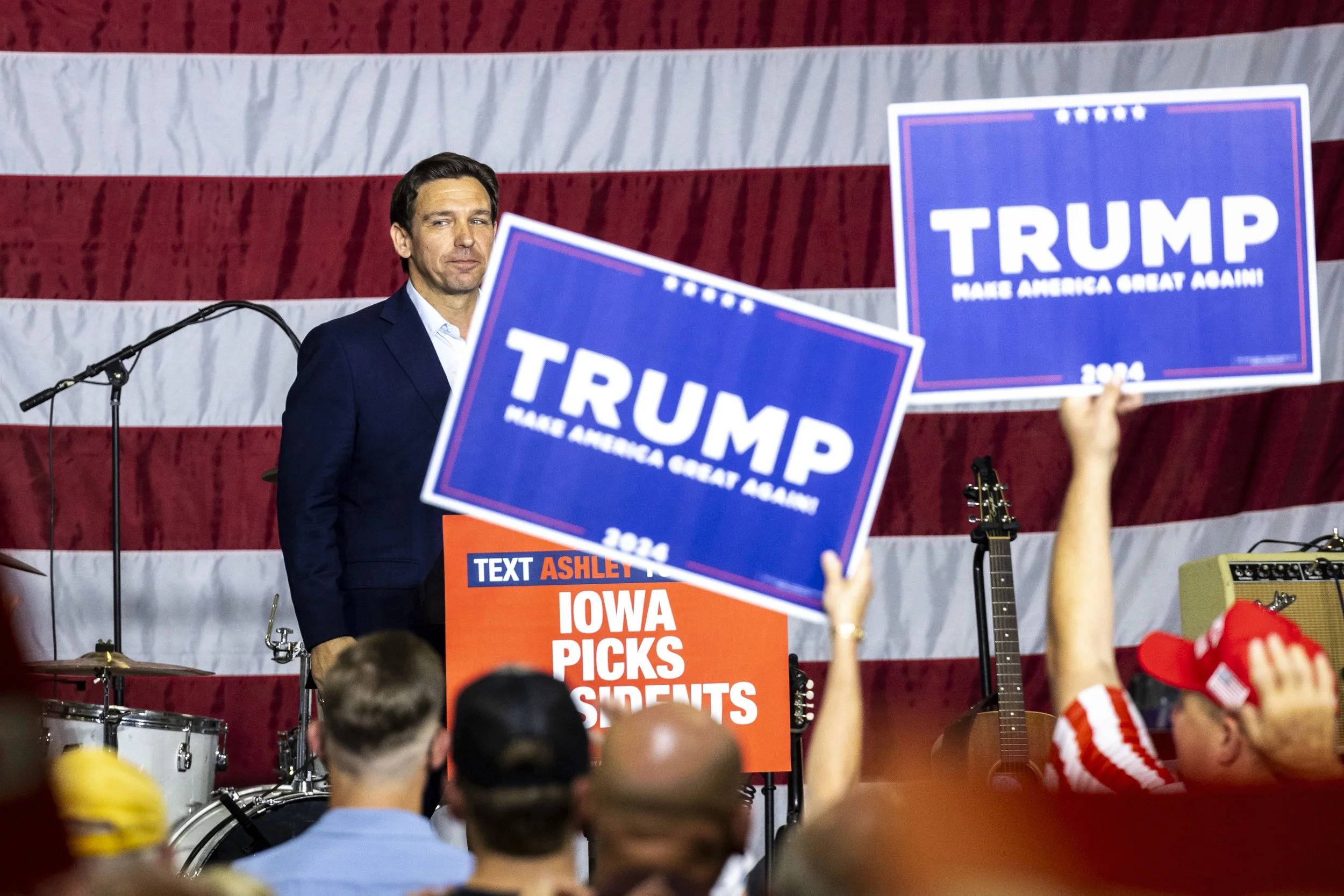  Republican presidential candidate Florida Gov. Ron DeSantis looks into the crowd after speaking as supporters of former President Donald Trump hold up signs during the Ashley's BBQ Bash fundraiser, Sunday, Aug. 6, 2023, at Hawkeye Downs in Cedar Rap