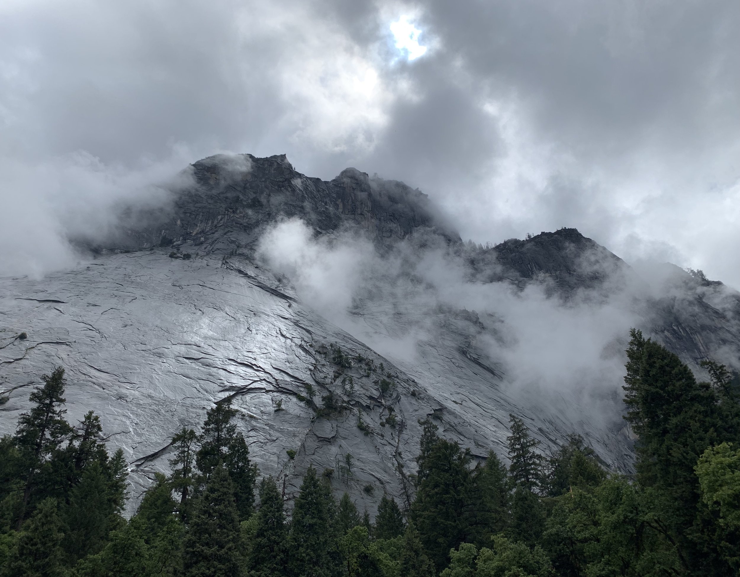 A wet granite face shot from the parking lot.