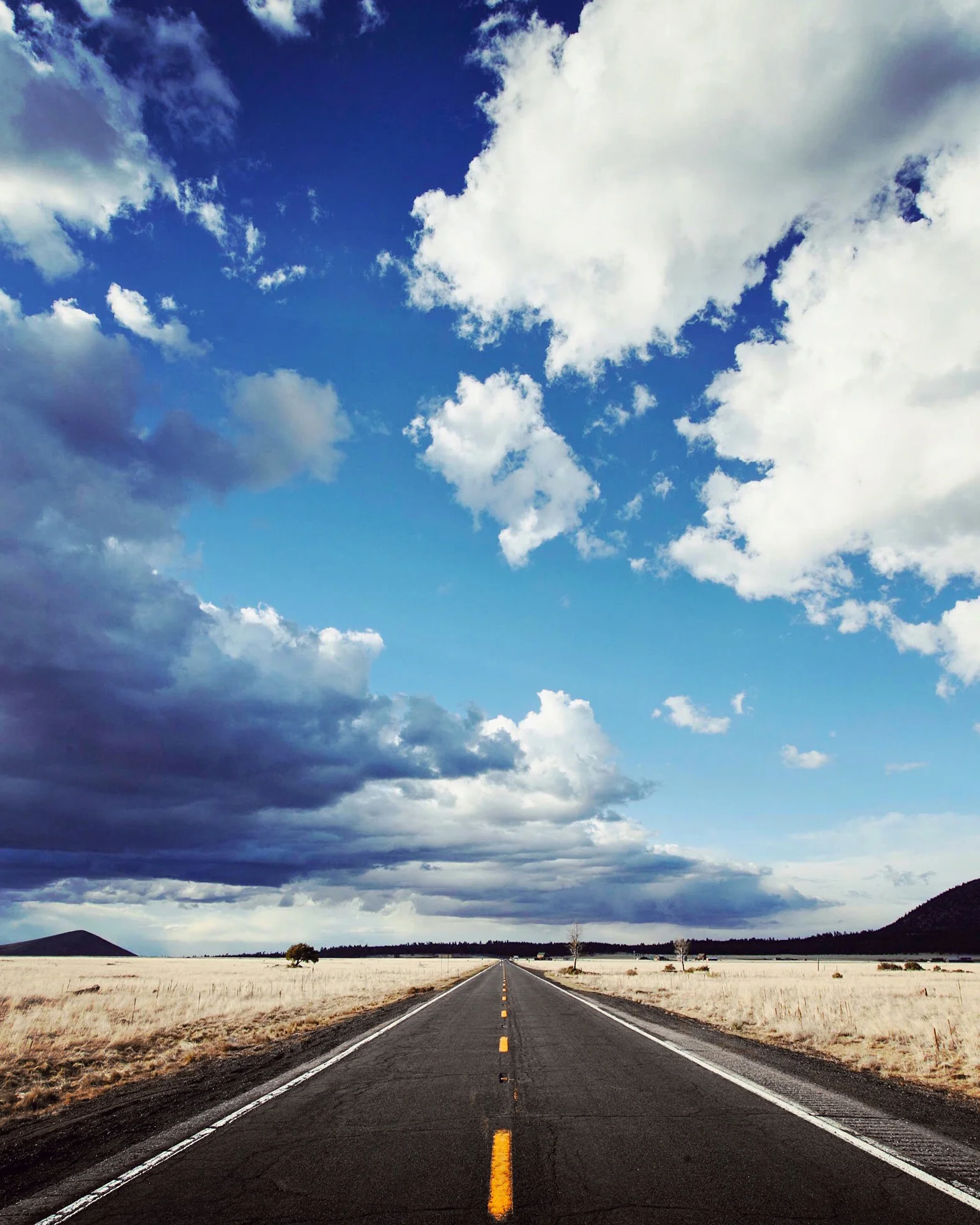 A classic #worldcycle view. The endless road. Straight and true. Vast &amp; breathtaking skies then bend across the horizon. A view that is both daunting and wonderful. As a sufferer of depression, some days this view would seem horrifying, endless, uncertain. Other days it would seem exciting, a path to freedom, a path into the beautiful unknown.  Many people think a ride around the world is “the trip of a lifetime”… after four years in the saddle I have come to realise that its no one trip, its no linear path to happiness. Its simply the life I lived at the time with some moments joyous, some painful and some just drifting. I learnt to take relish in the highs whenever they came along. We cannot always see what's down the road and, over time, day after day, we can start to accept that.