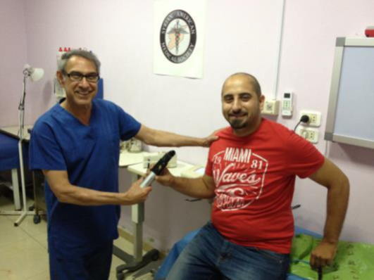 Dr Francis delivers the new piece of diagnostic equipment to Mahmoud of PCRF.
