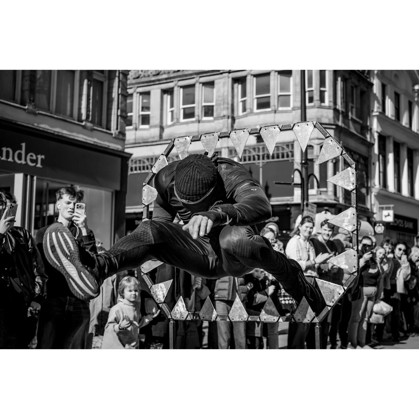 Far more interesting than shopping, watching a guy jump through sharp knives and hoops of fire. 🔥🔪😮☠️

#leeds #streetperformer #blackandwhite #streetstunt #bnwstreetphotography