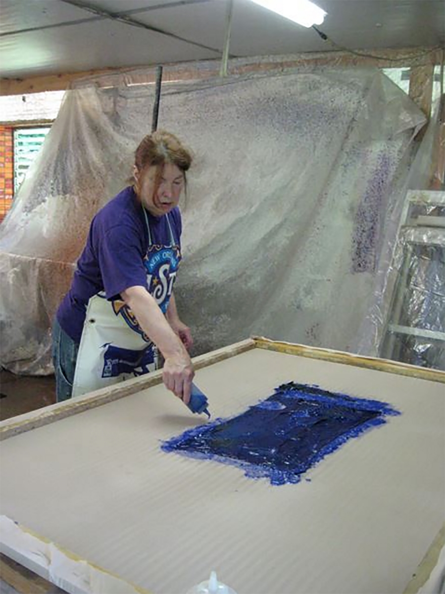  Kathleen is pulp painting on her large paper piece after a layer of abaca pulp was sprayed on the cloth to start.   