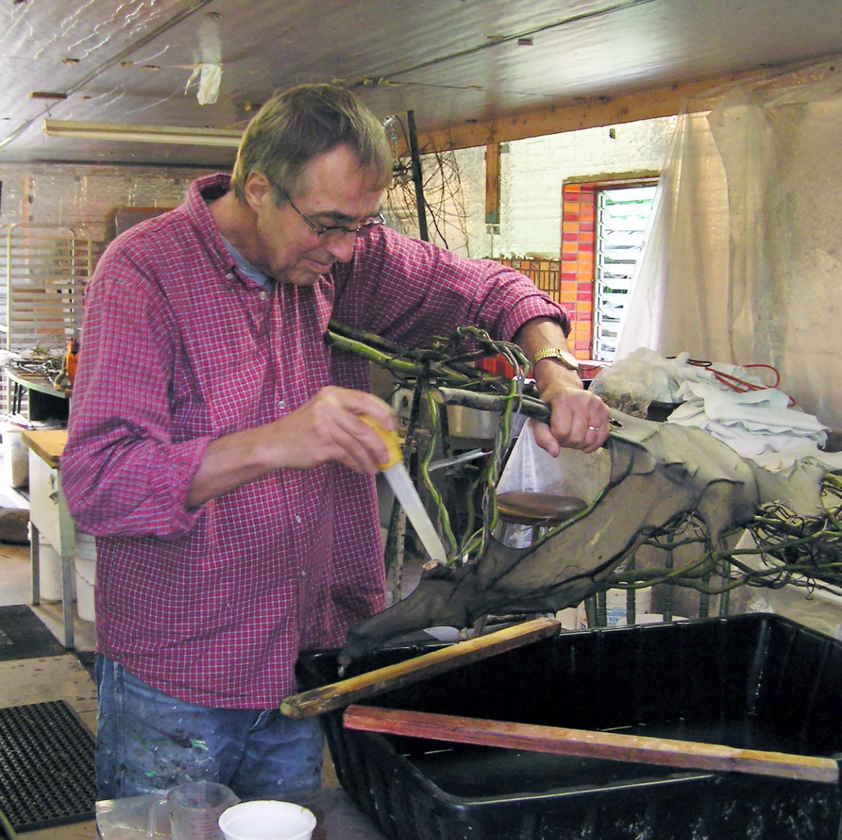  Henry at work applying pulp to smaller areas of his sculpture with a turkey baster. 