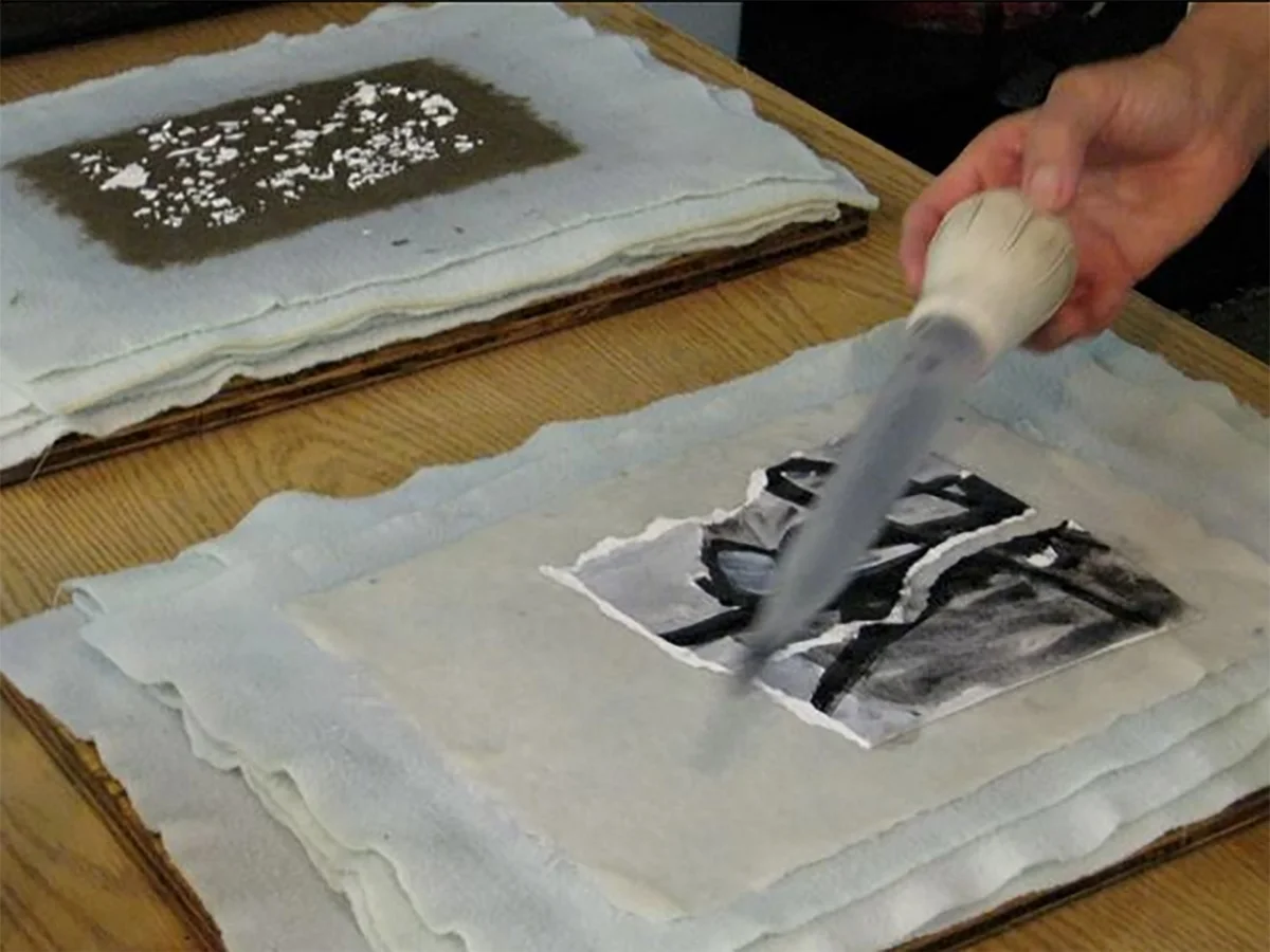 Here, Liliana is building a collage with torn bits of her paintings and handmade paper pulp from abaca and other plant fibers.