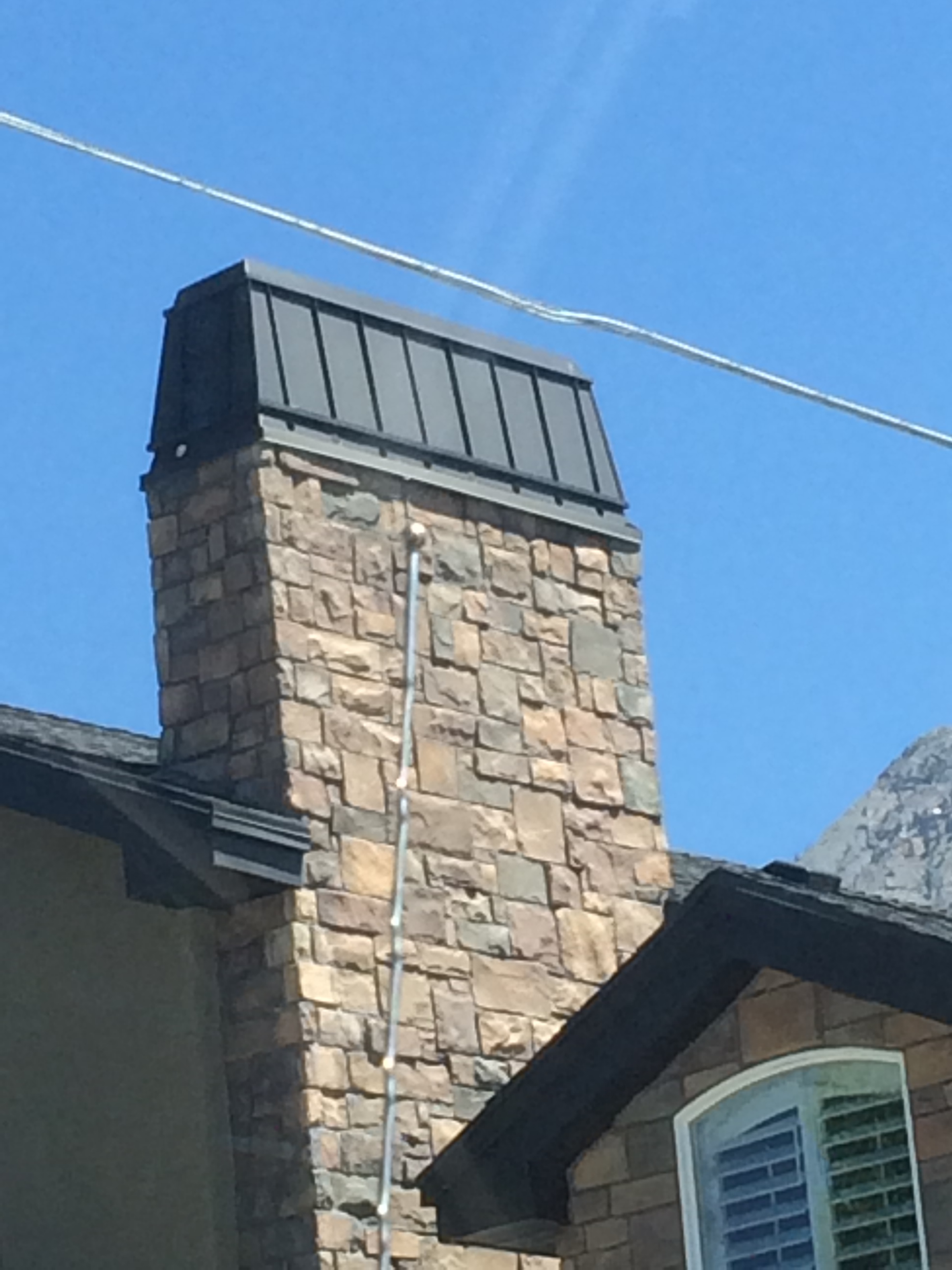 rooftop-accent-stone-and-chimney-cap.jpg