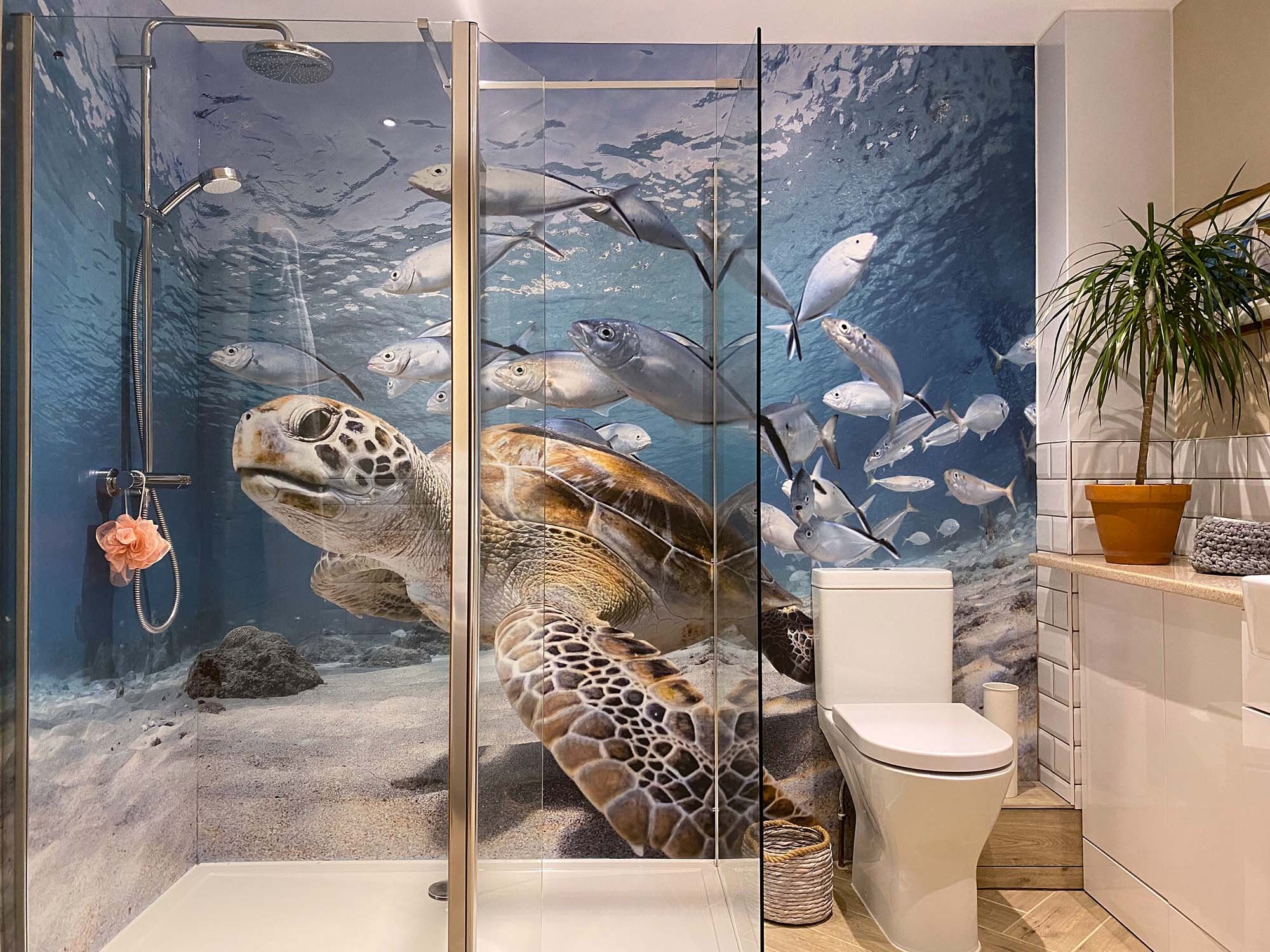 Family bathroom walk-in shower with printed photo shower panels around shower walls. Turtle design with clear blue seas and silver fish swimming
