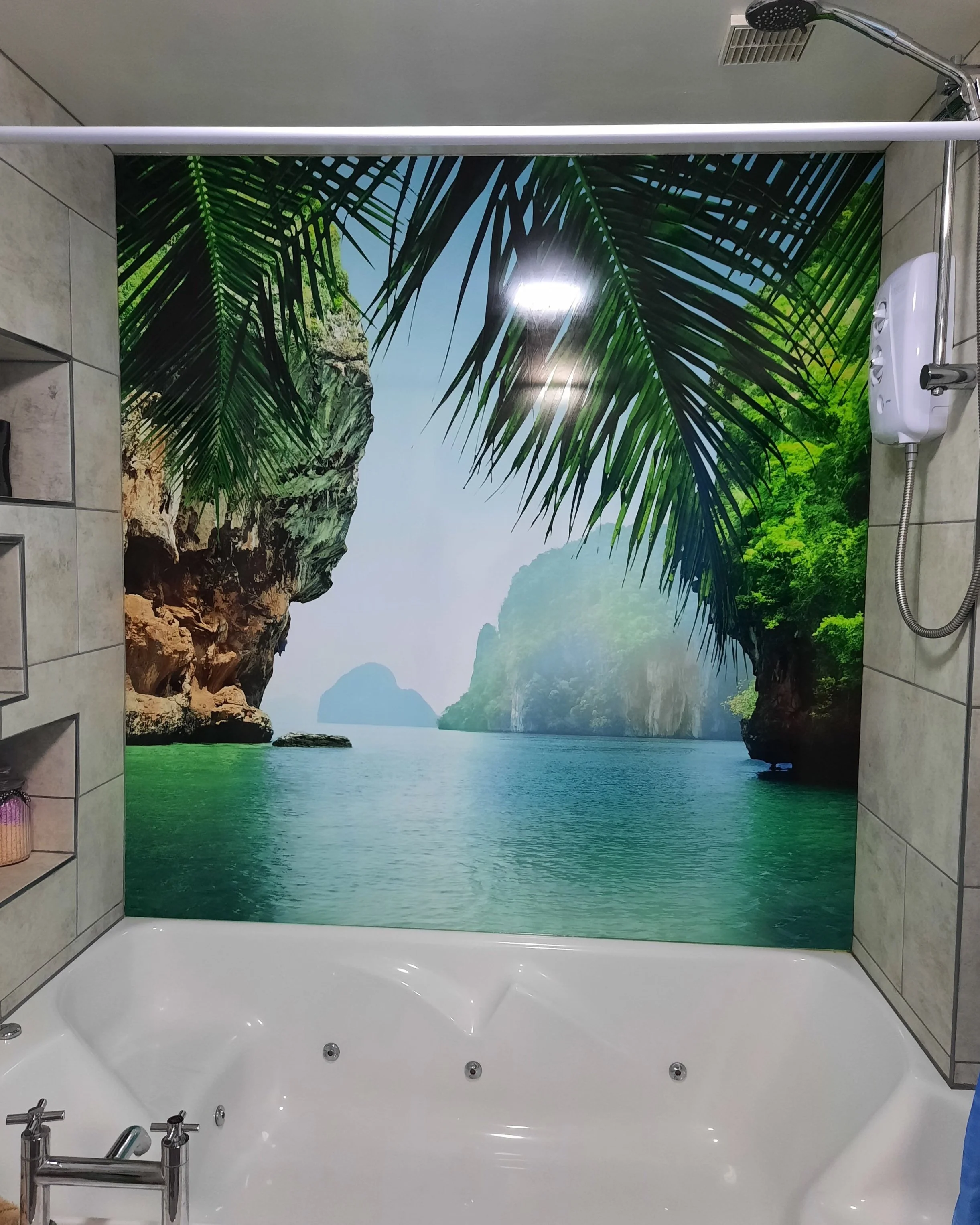 Tropical feature bath wall panel with image of Thailand bay with warm green sea, tall cliffs and palm tree leaves.