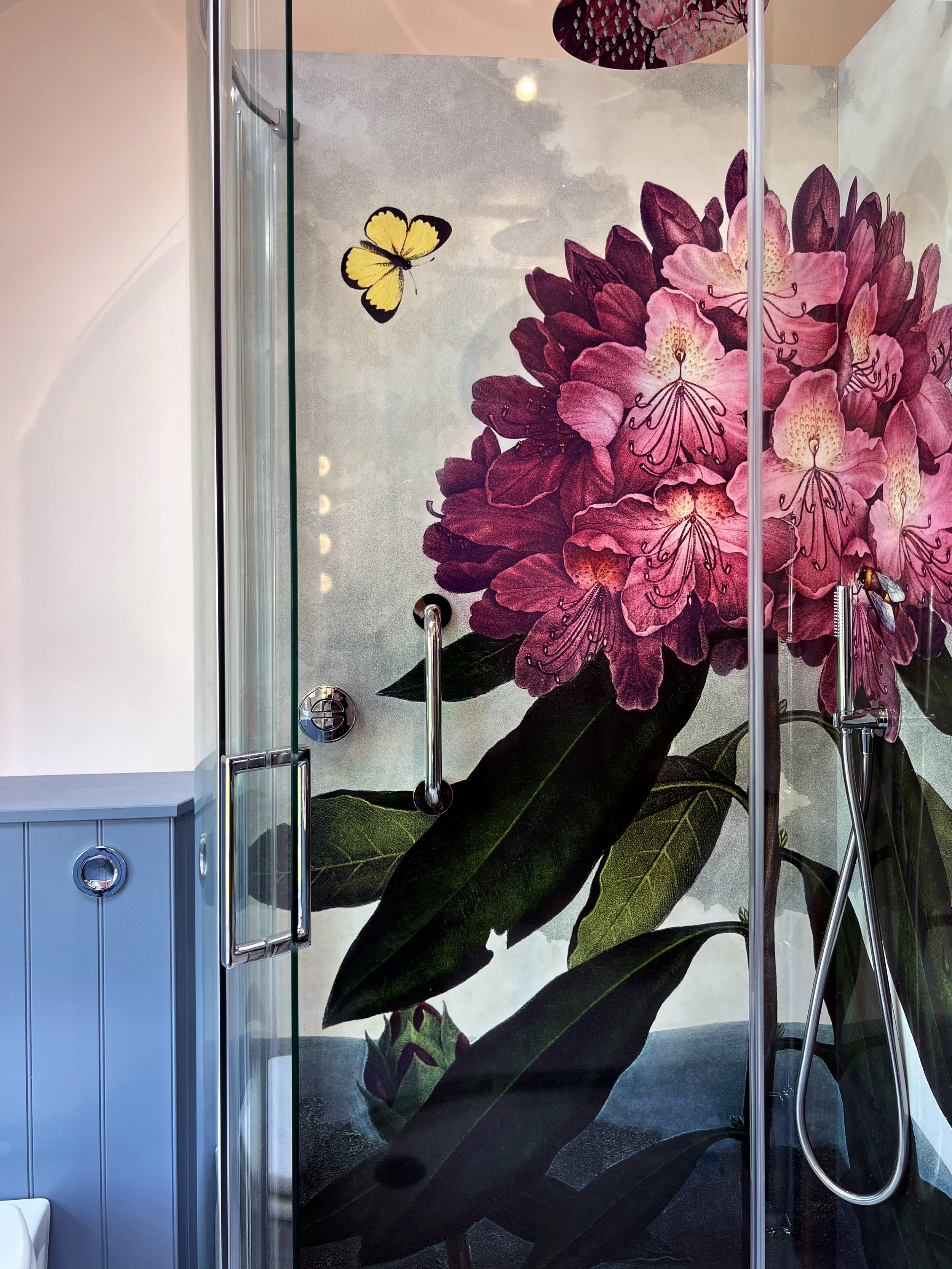 Rhodedendron image shower panel, installed in a corner shower enclosure. Pink flowers with butterflies and bees.