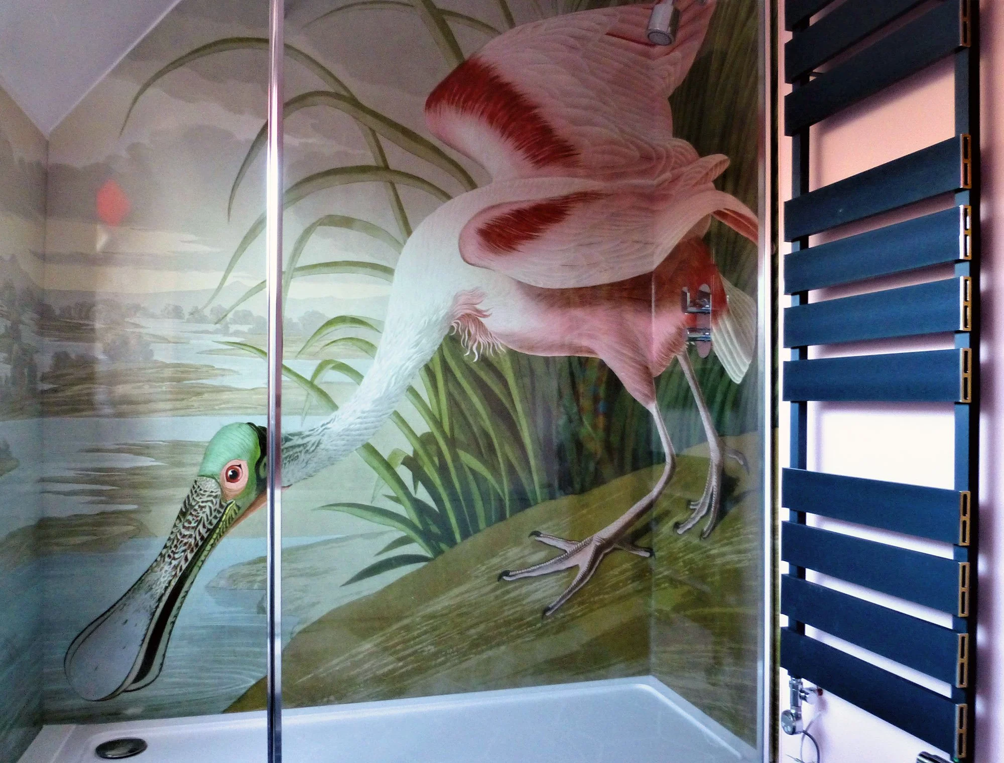Spoonbill art print shower panel installed in a customer shower. Audubon bird shower feature wall, with white shower tray, dark grey towel rail and glass shower sliding door.